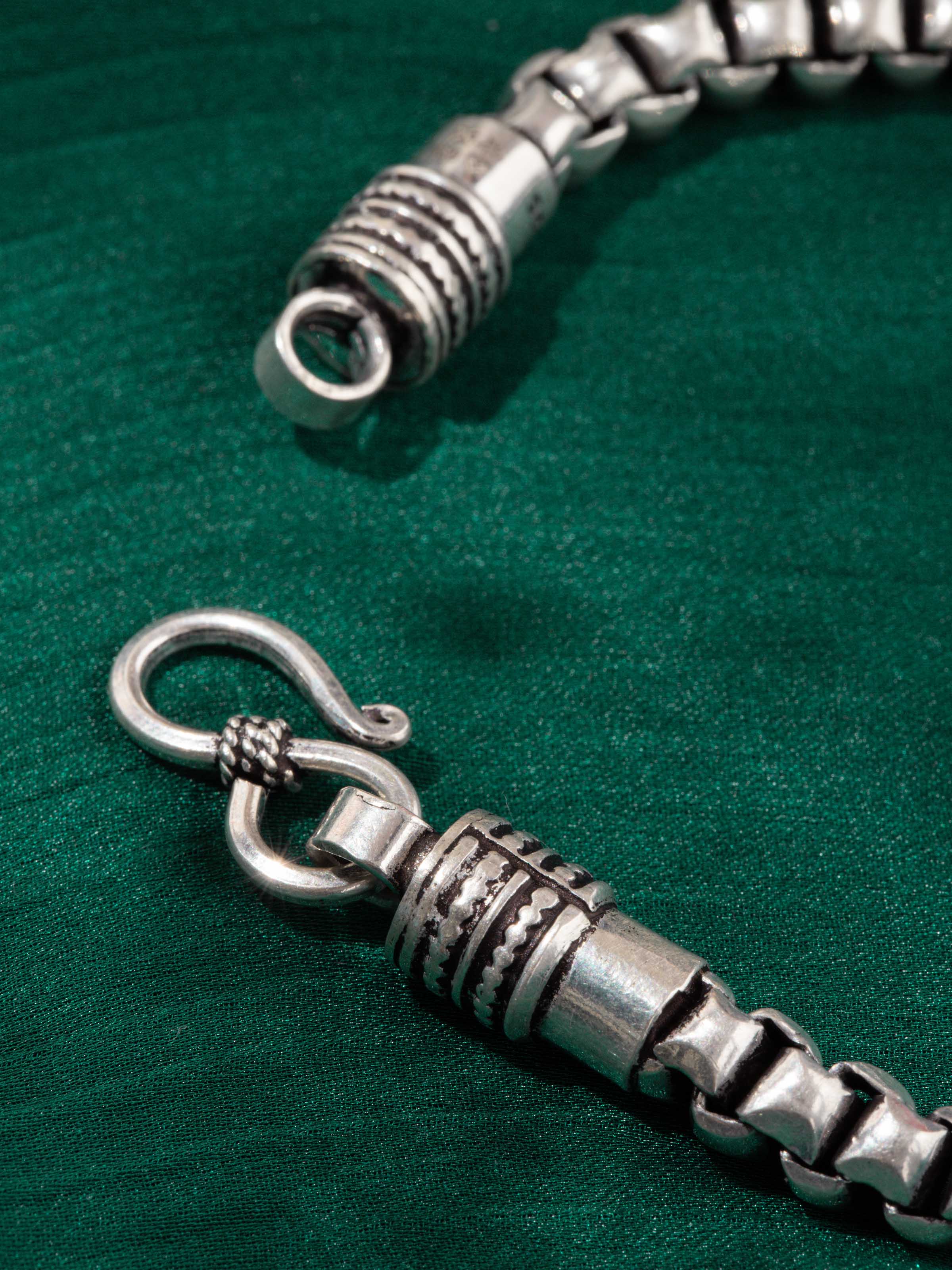 Detail shot of silver flexi bracelet capturing textured links and clasp design