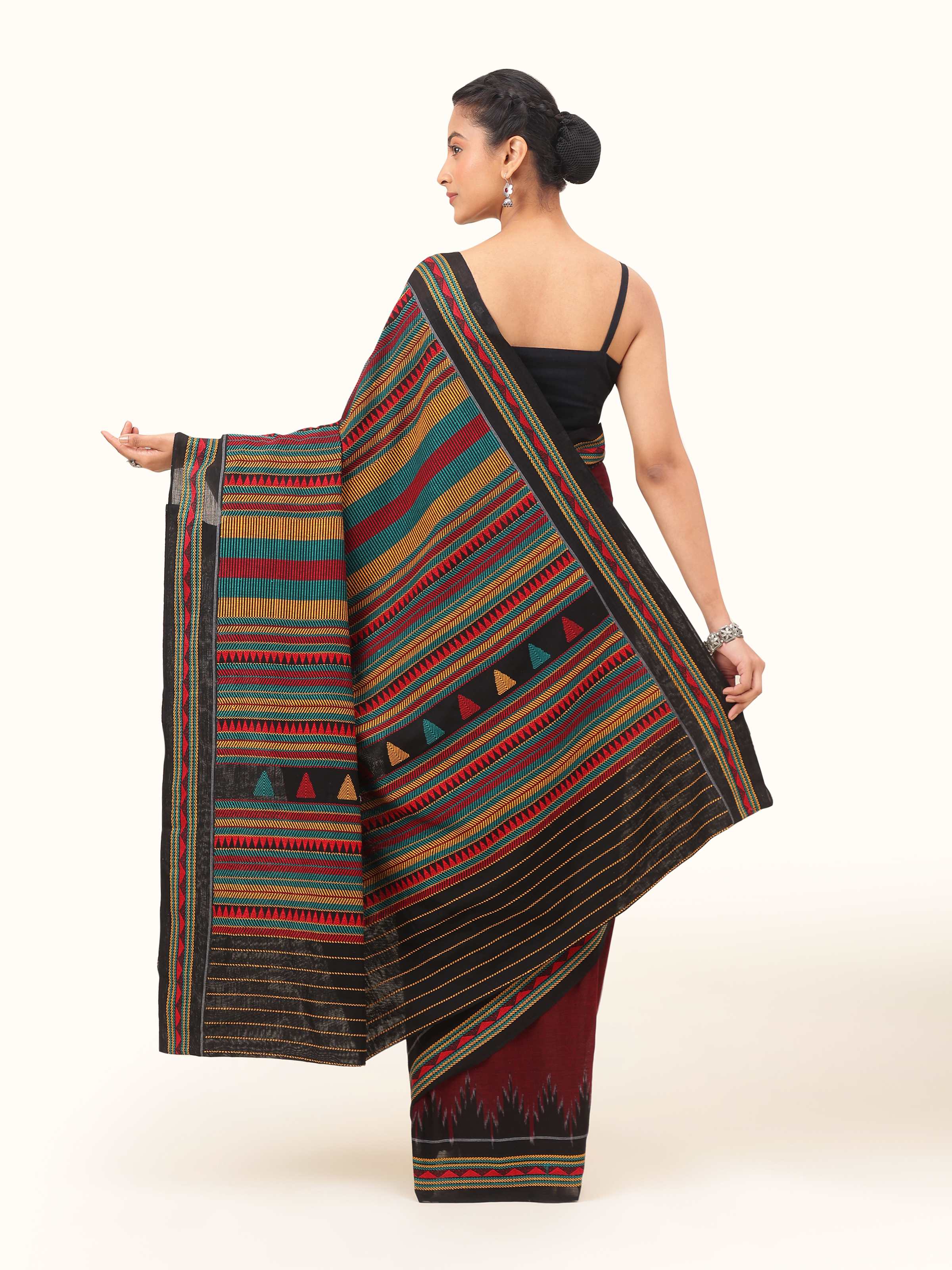 Back view of red cotton Dongaria saree showing full pallu with intricate tribal motifs