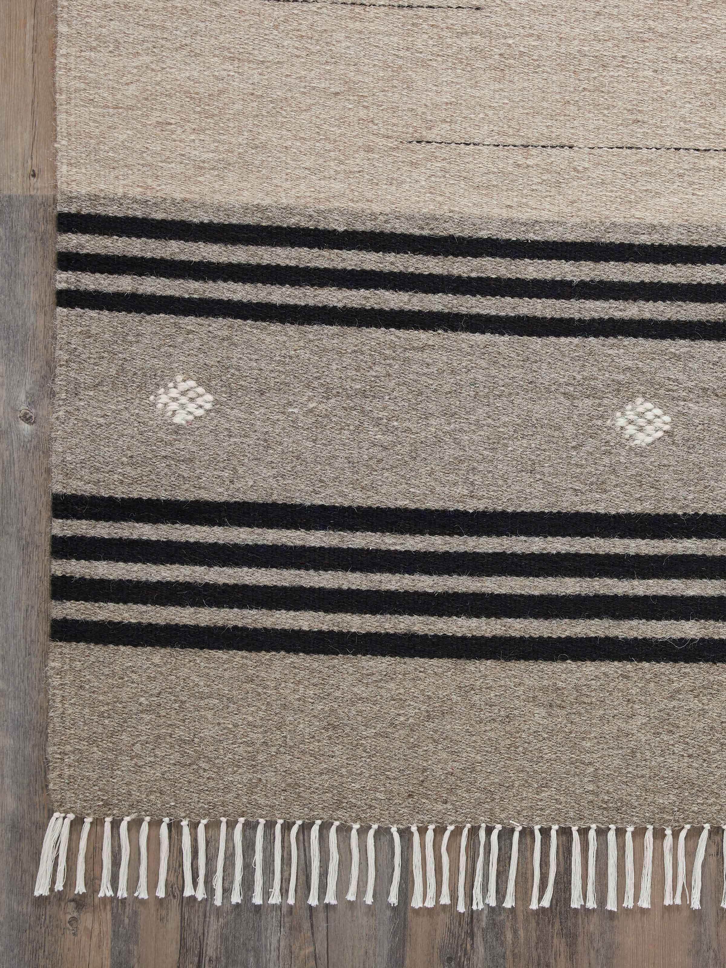 Full view of Nomad stripes beige black Jawaja wool & cotton handloom dhurrie (3x5 ft) spread out, emphasizing its striped design