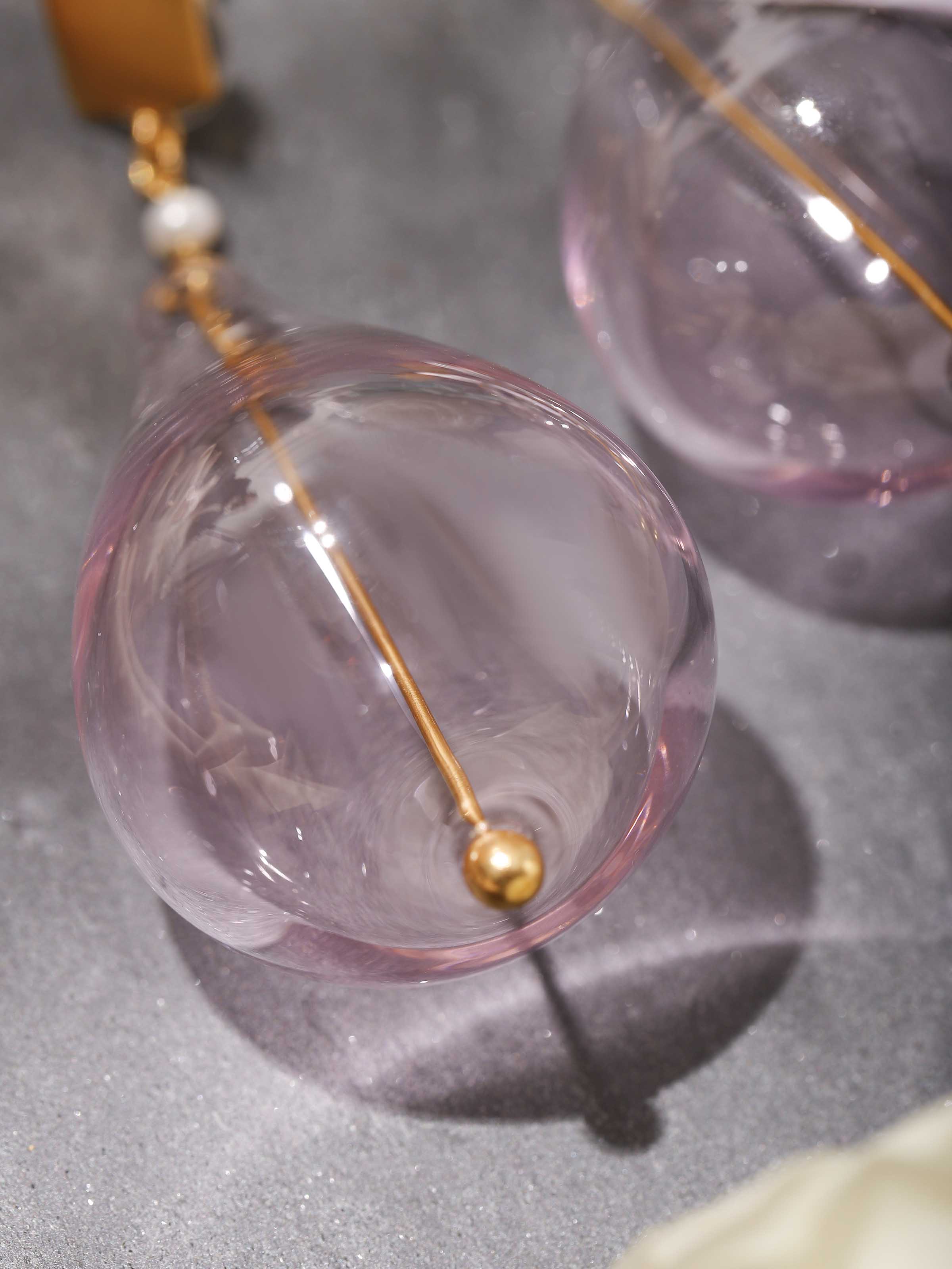 Detail shot of silver flame glass drop earrings