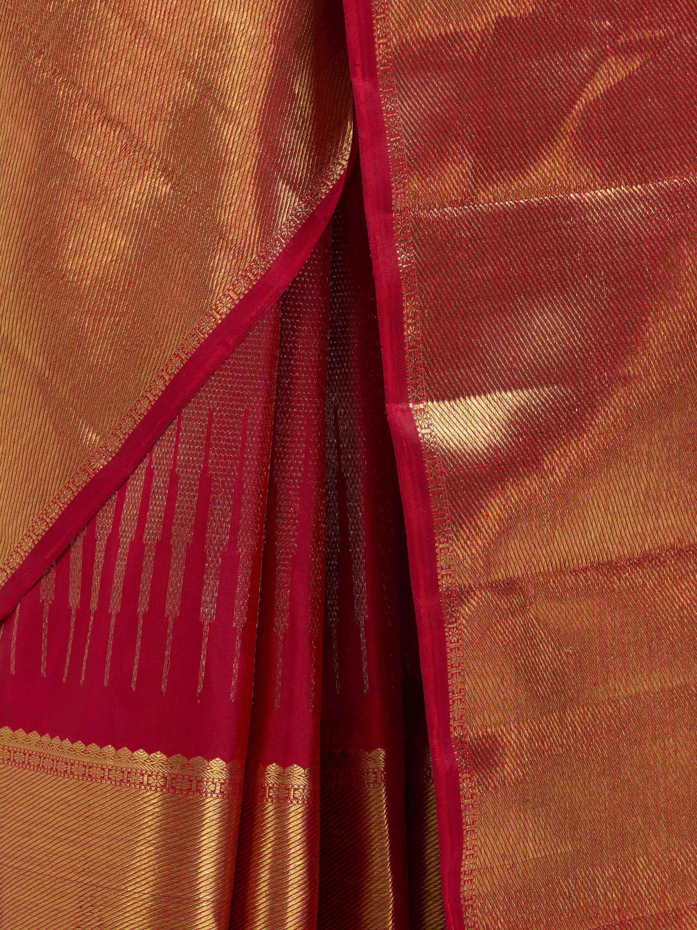 Detail view of red silk Kancheepuram saree showing silk texture and zari craftsmanship
