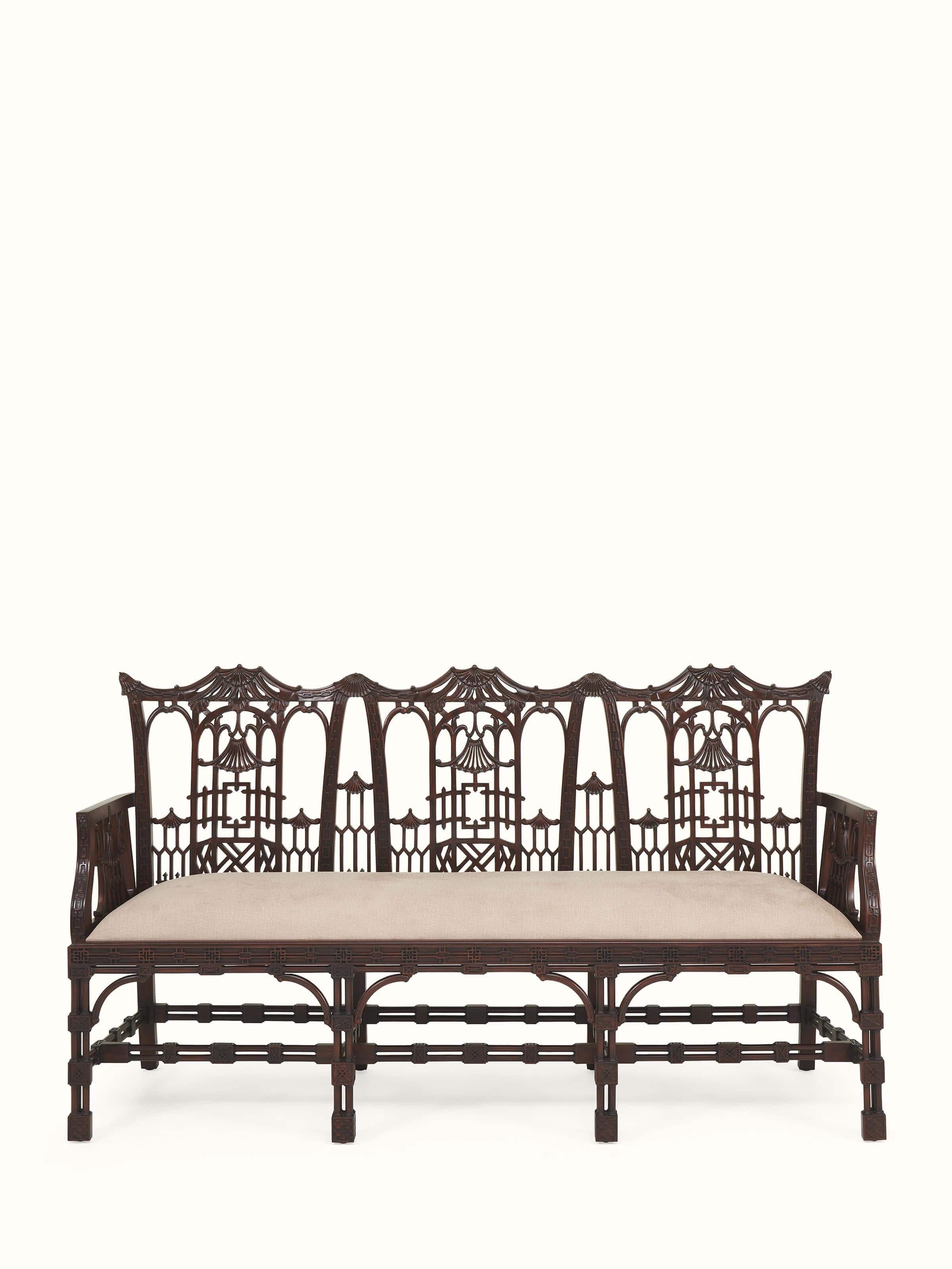 Front view of upholstered mahogany wood 3-seater sofa featuring deep cushions and carved wooden frame