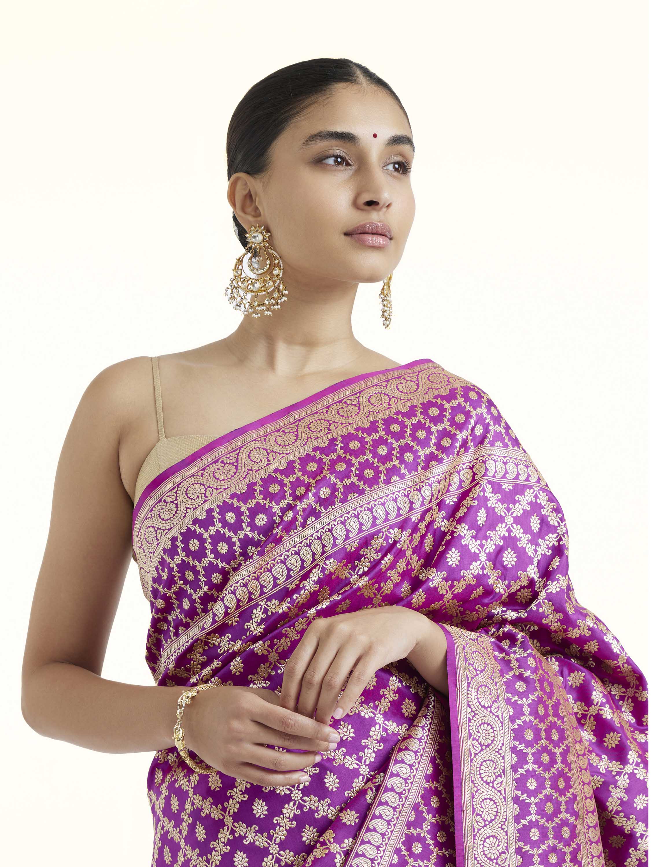 Angled view of purple katan mulberry silk Banarasi saree highlighting woven patterns