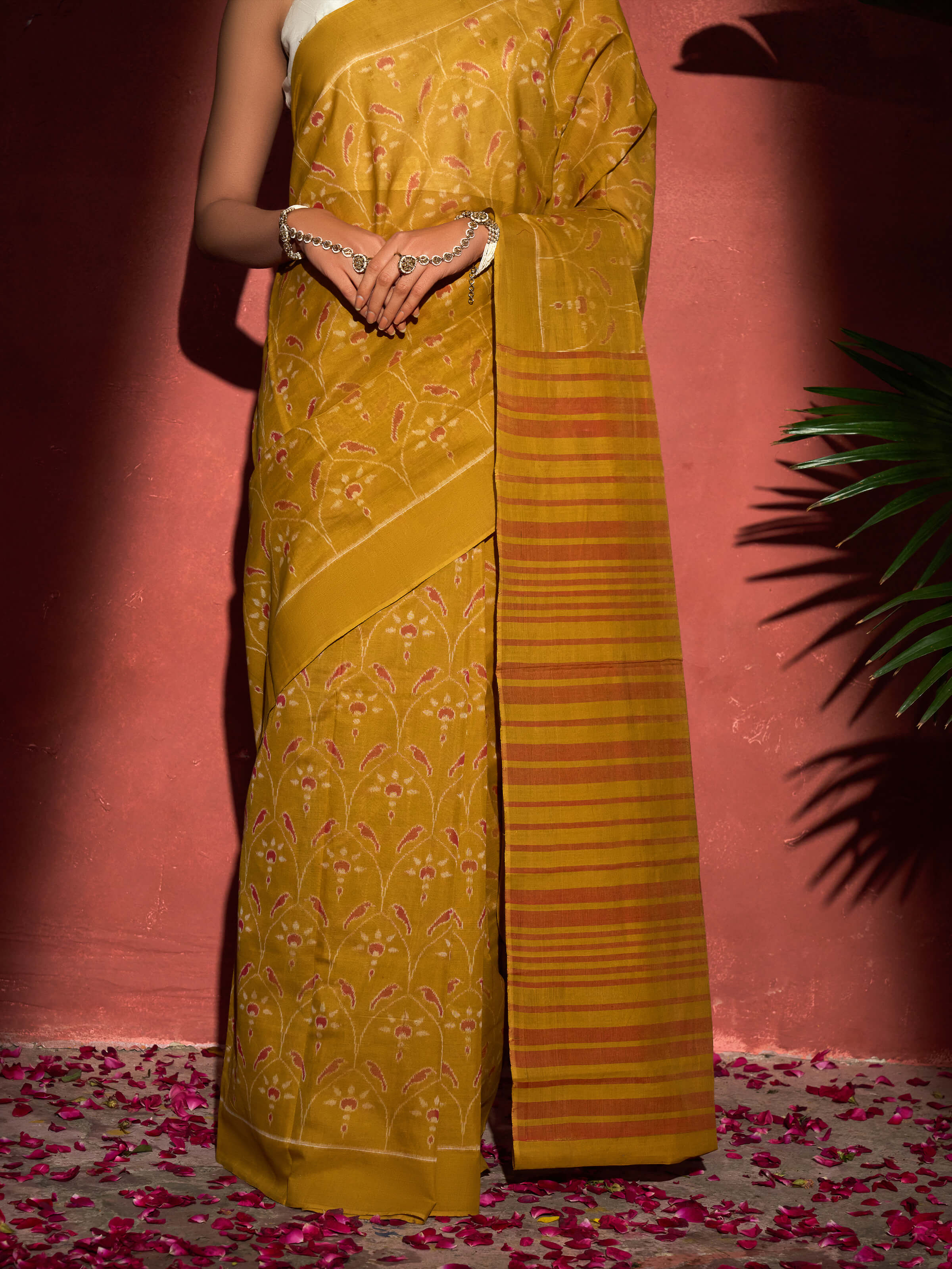 Detail view of mustard cotton Odisha ikat bandha saree showing fabric texture and dye patterns