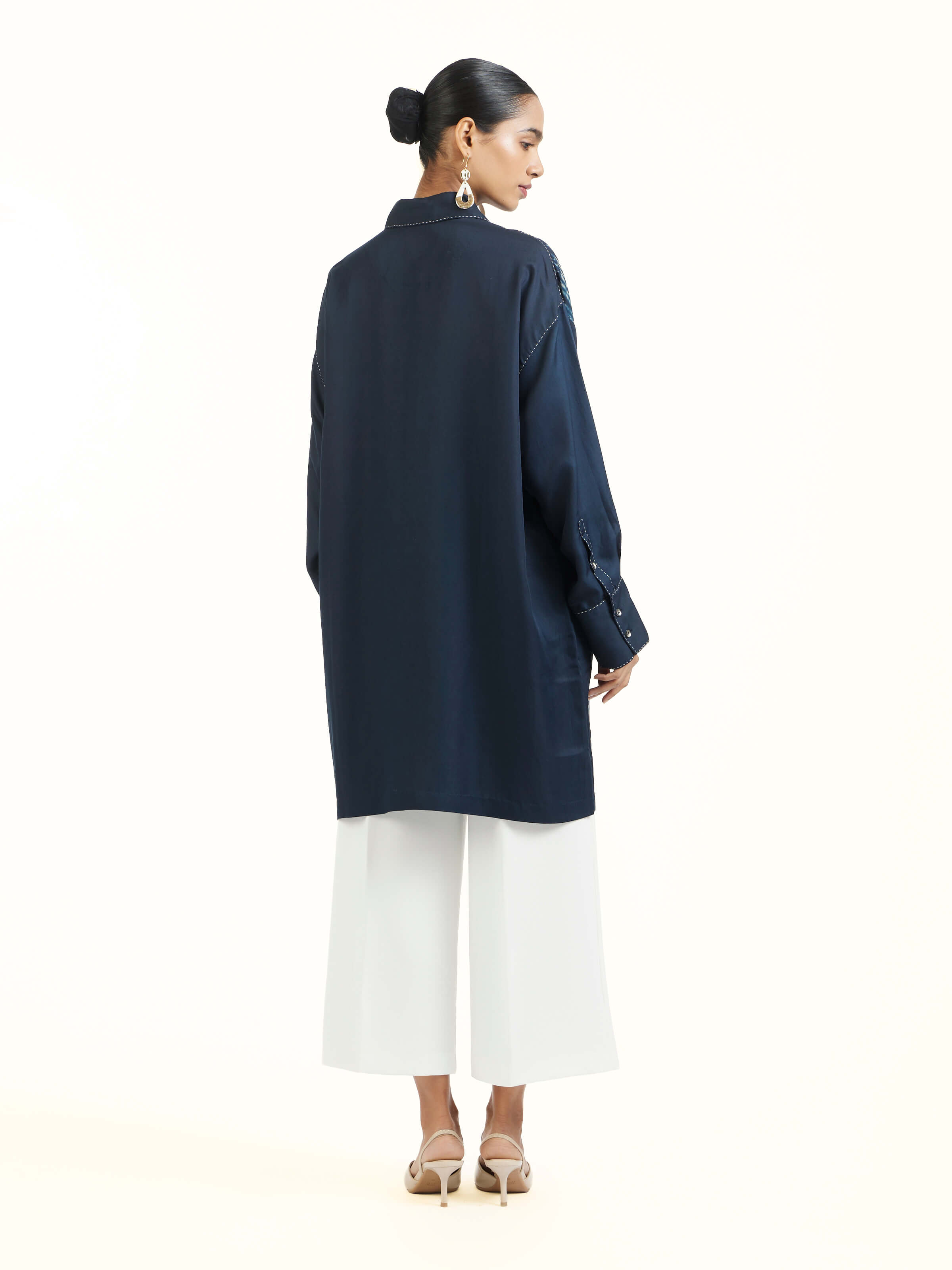 Back view of blue shibori long shirt showing full length design