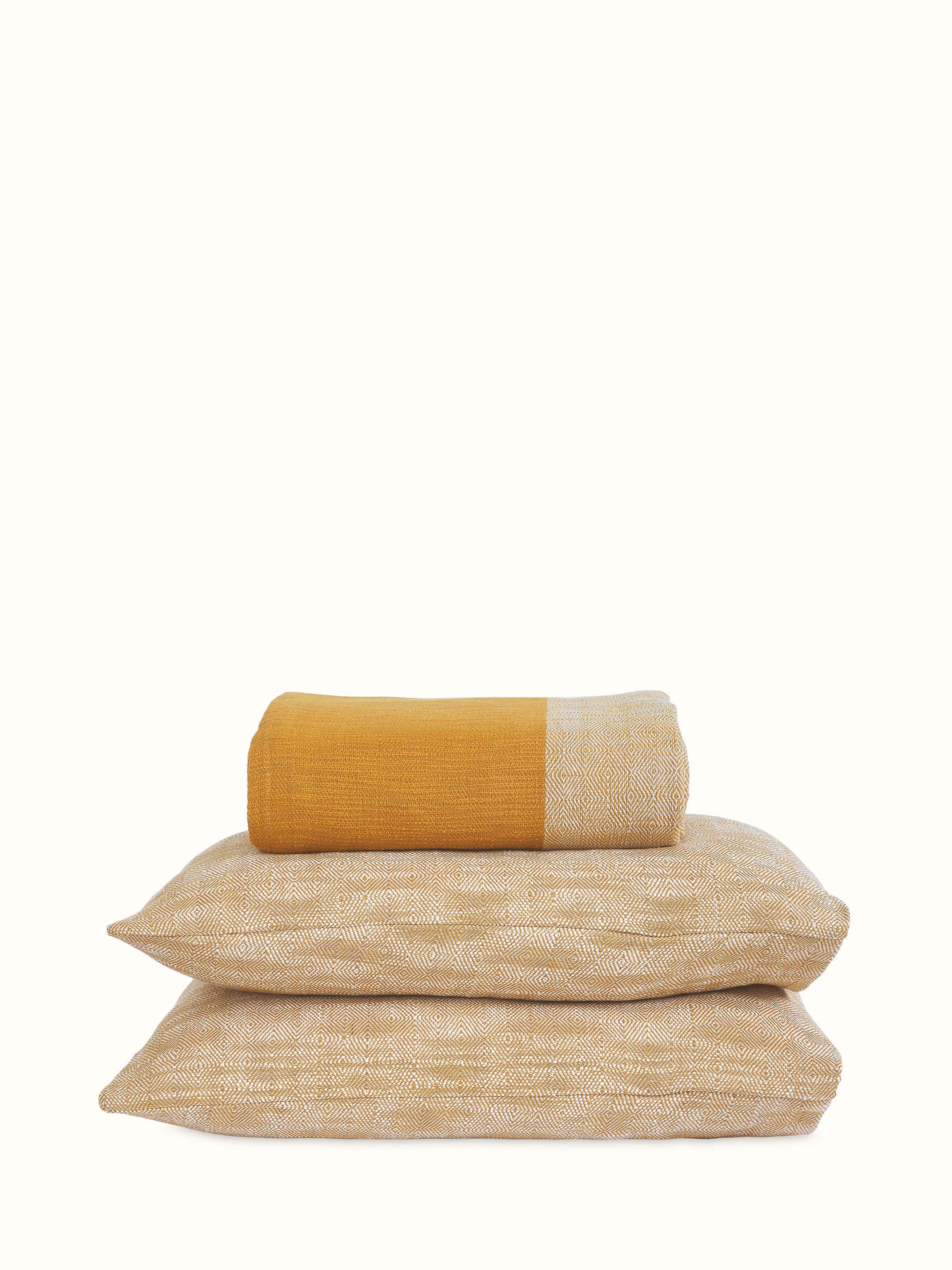 Front view: Front view of king-size yellow cotton handloom bedspread with soft texture and minimal design.