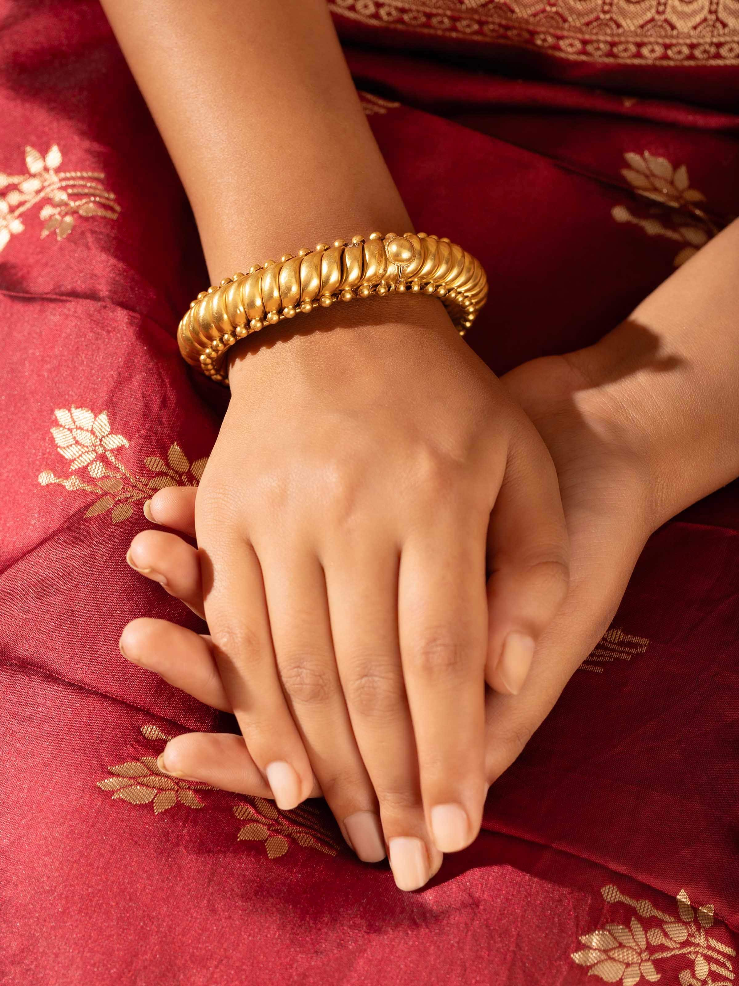 Close-up view of Smithing Bangle emphasizing the intricate details and traditional metalwork