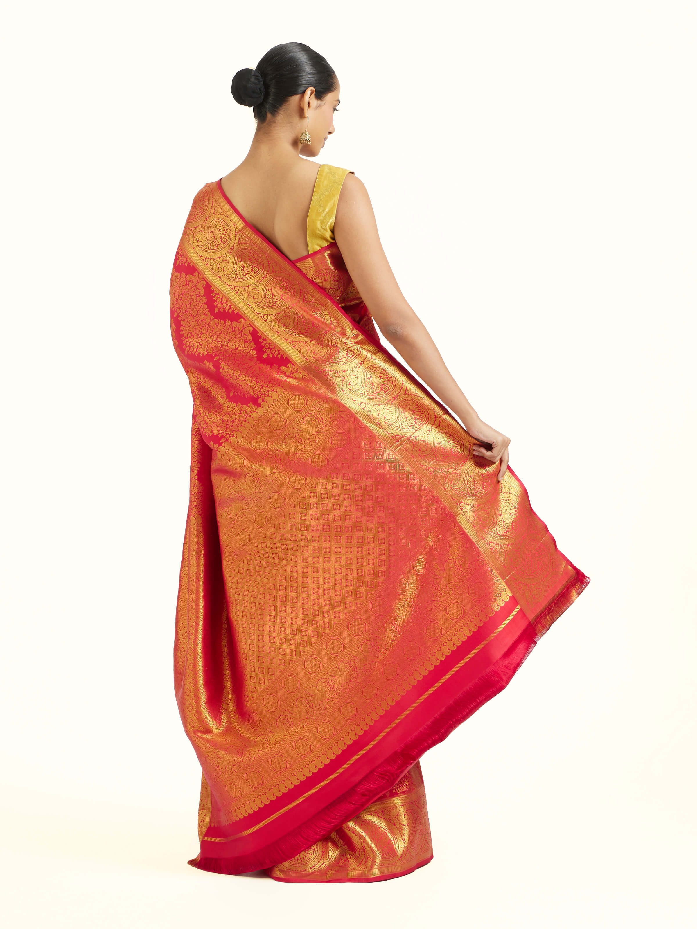 Back view of red silk Kancheepuram saree displaying ornate pallu design