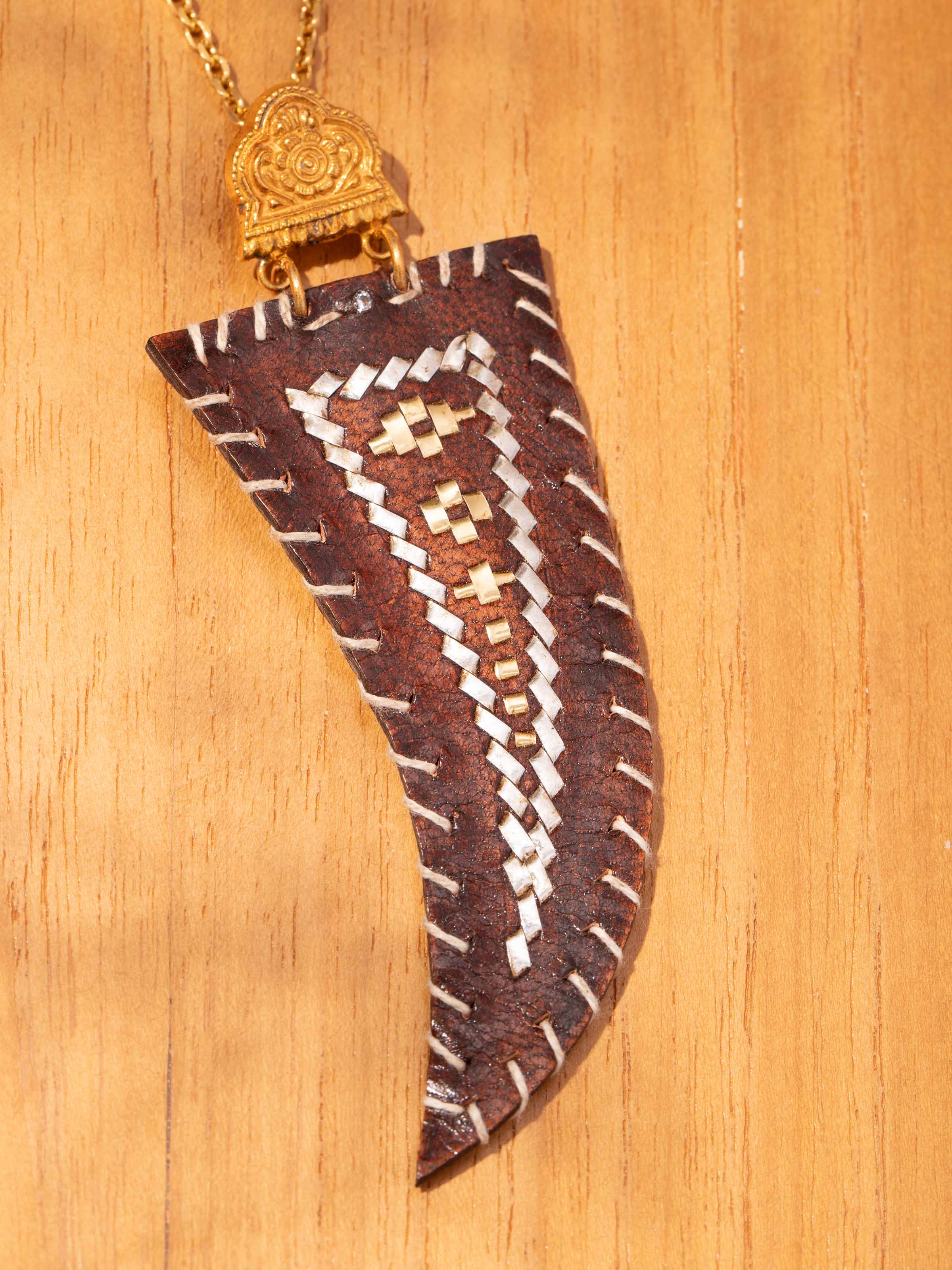 Detail shot of Kutch pendant capturing intricate leather work and oxidised silver finish