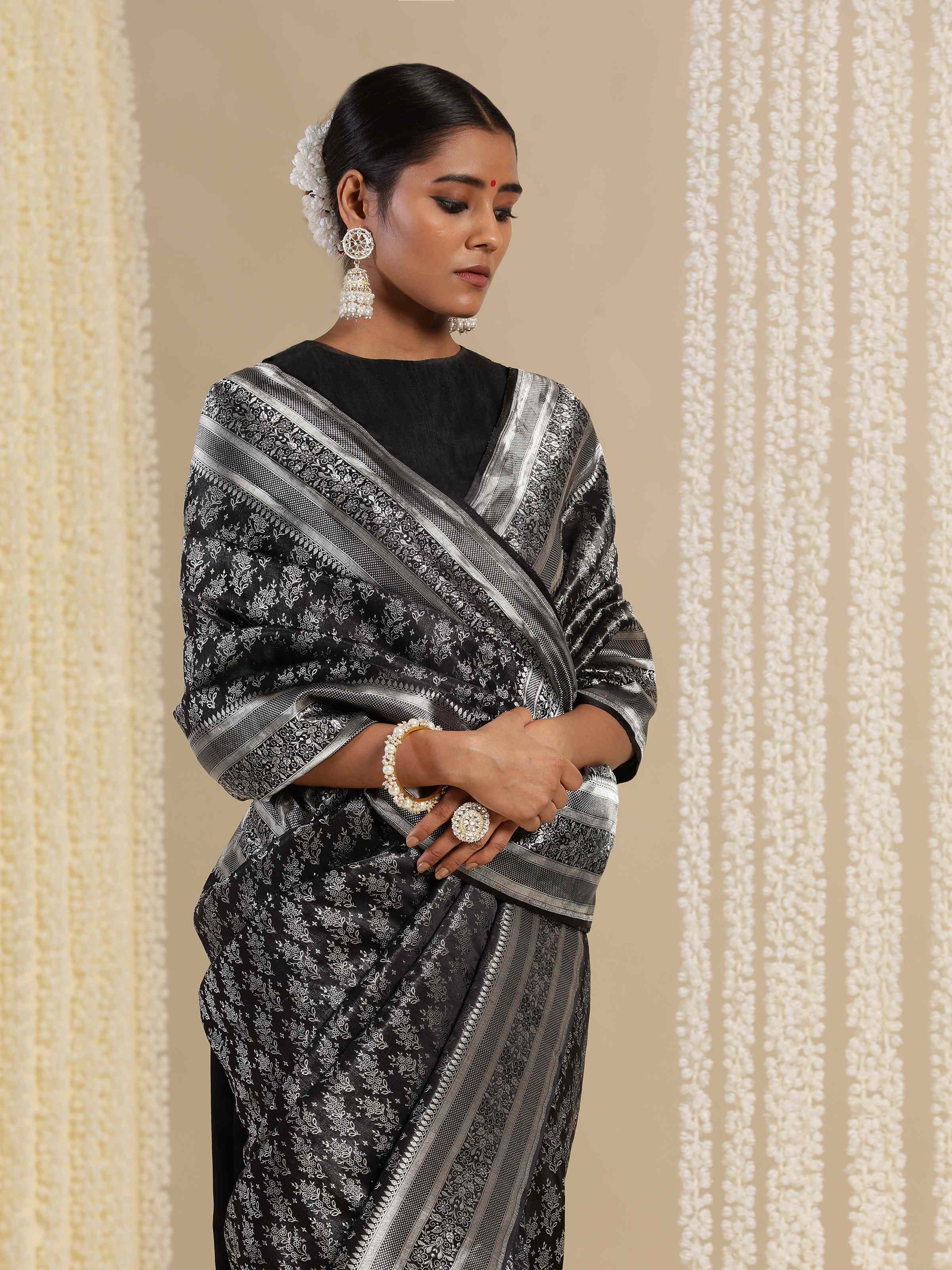 Detailed shot of Black Silk Satin Tanchoi Banarasi Saree pallu with intricate designs.