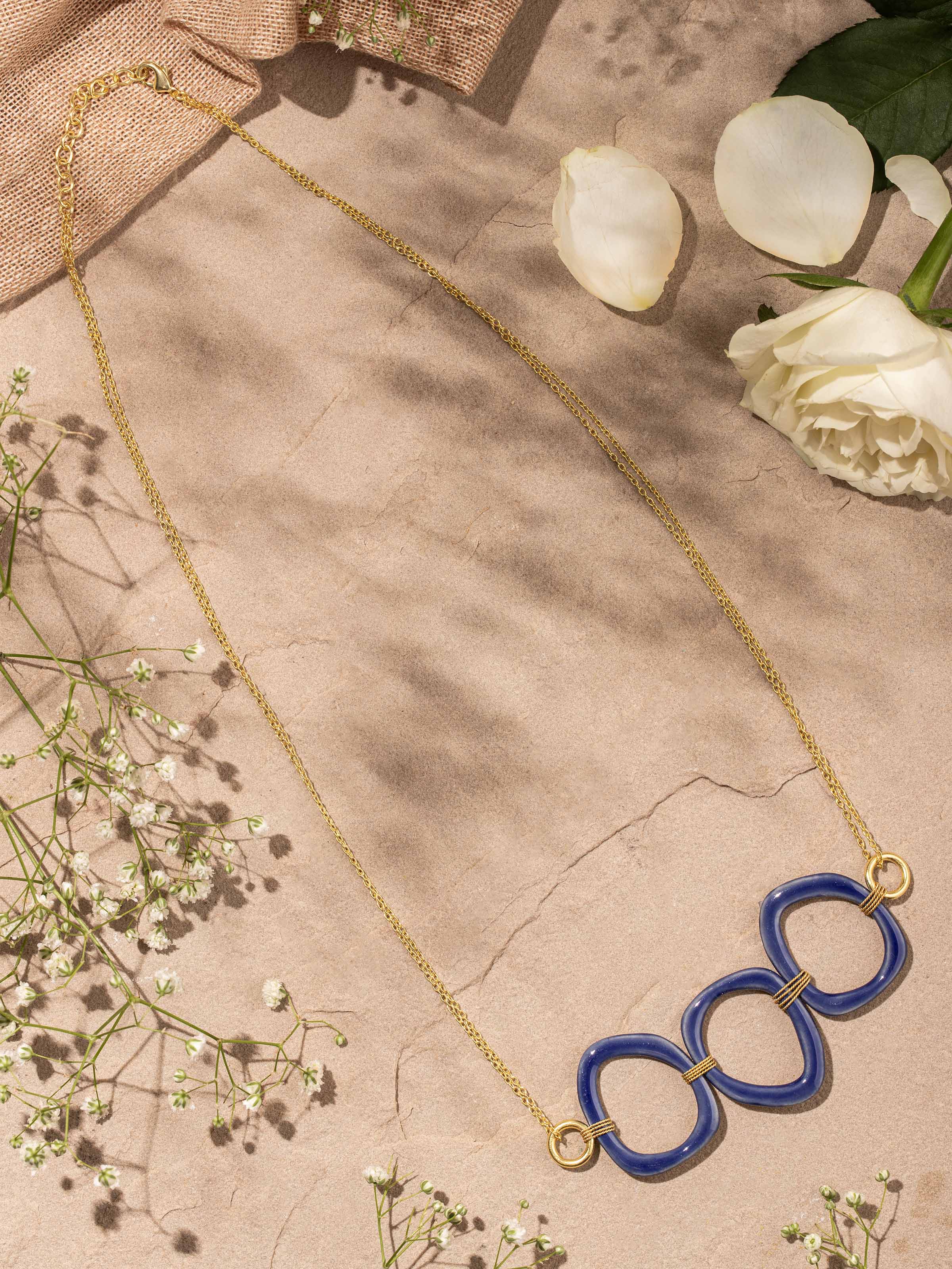 Side view of ceramic long necklace showcasing unique ceramic pendant and artistic detailing