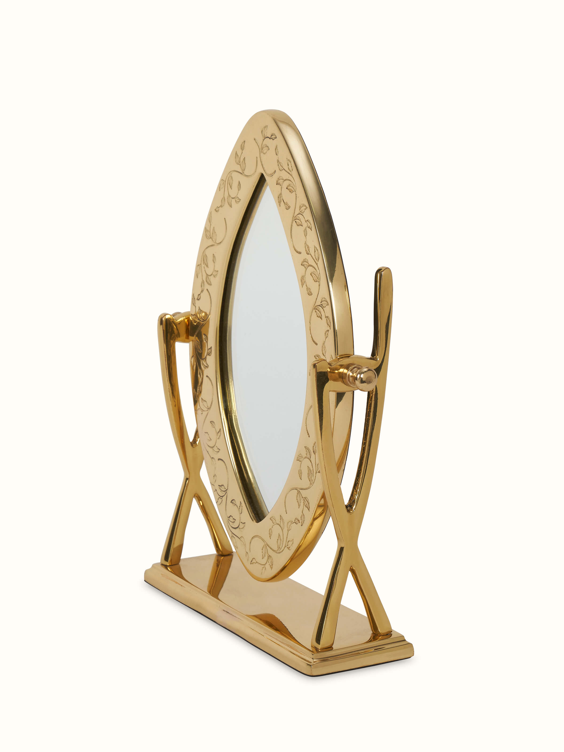 Angled view of brass-plated table mirror highlighting its craftsmanship