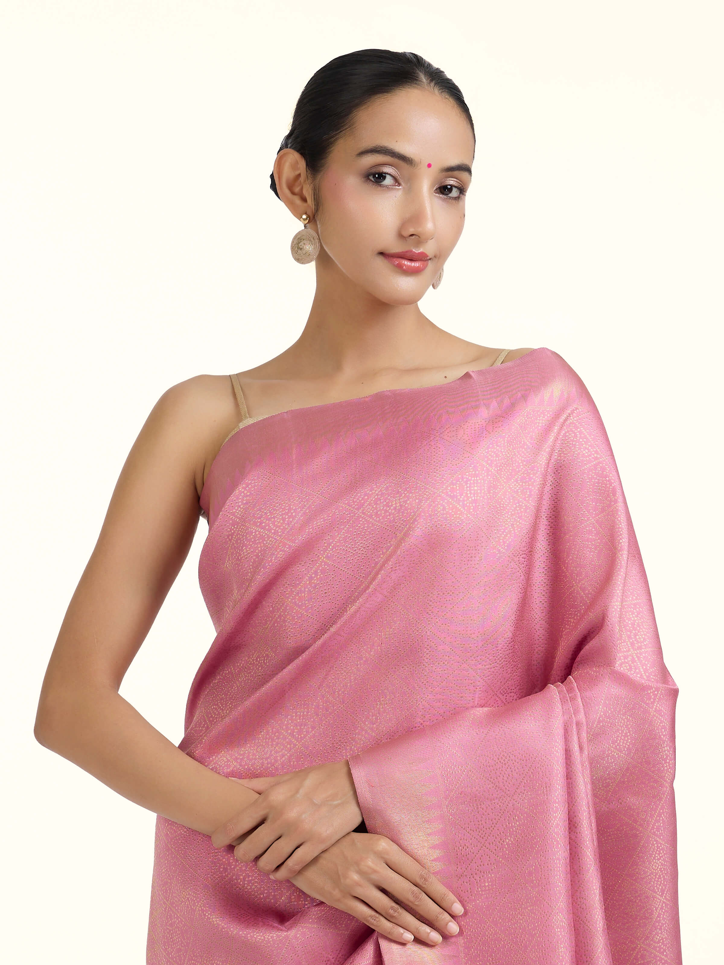 Angled view of light pink silk Kancheepuram saree highlighting traditional weave