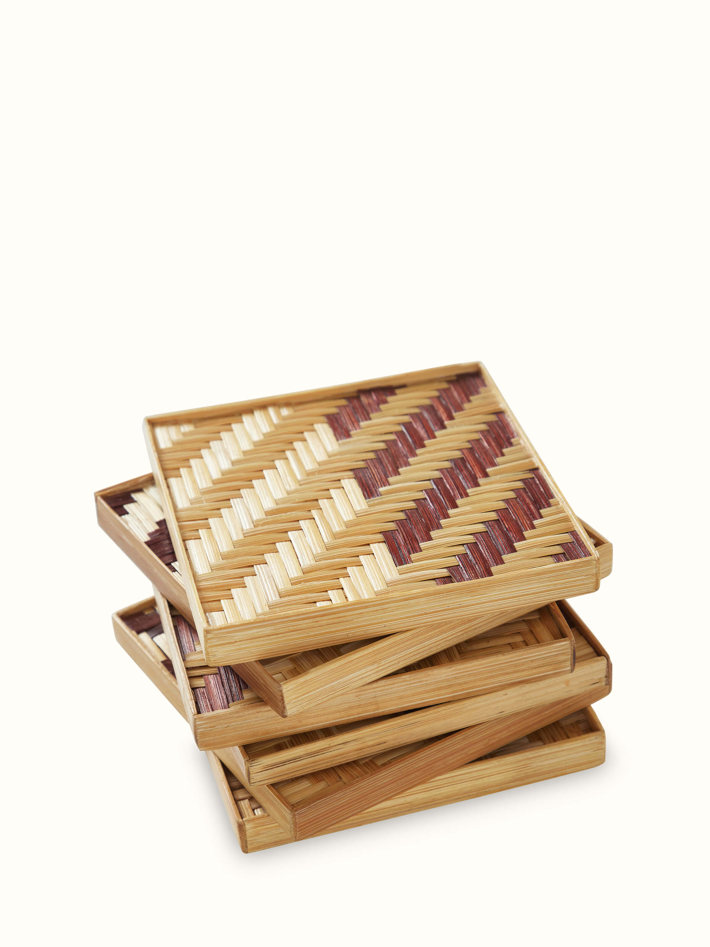 Angled view of Naveena bamboo coaster showing square shape, natural grain, and precise geometric pattern.