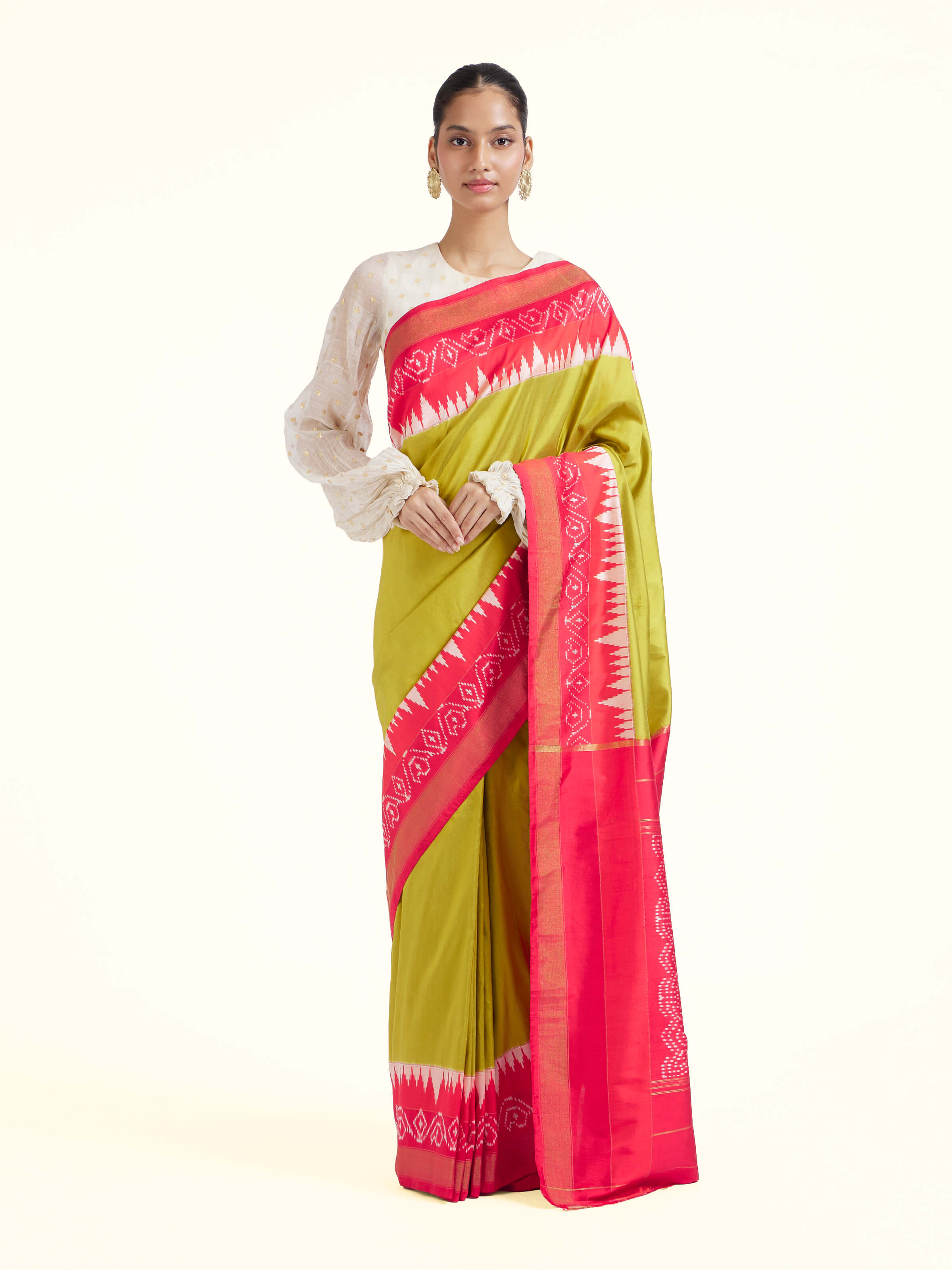 Front view of mustard mulberry silk ikat saree with bold woven motifs