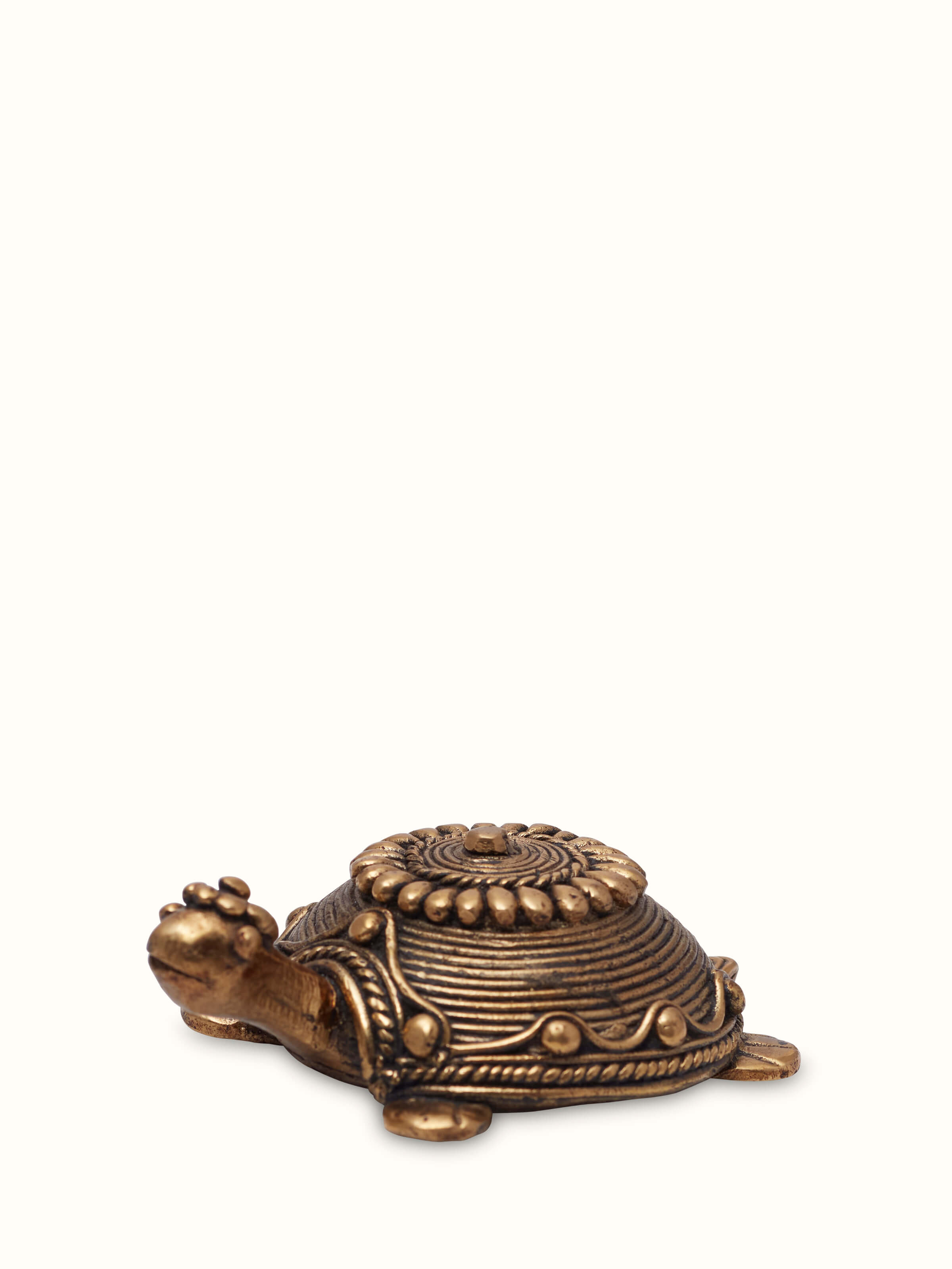 Angled view of dhokra tortoise brass figurine from side perspective