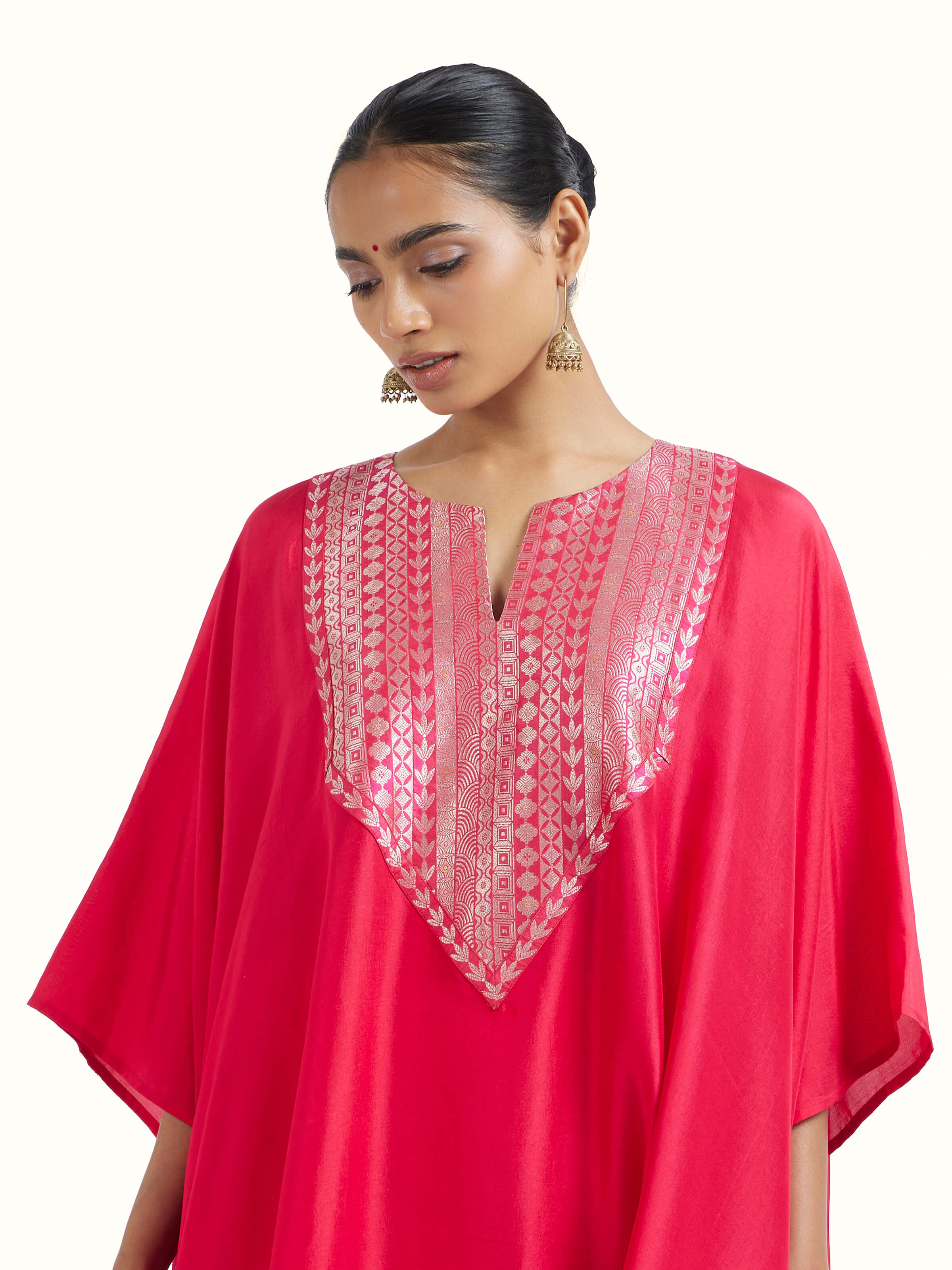 Angled view of red silk Banarasi co-ord set emphasizing silk sheen