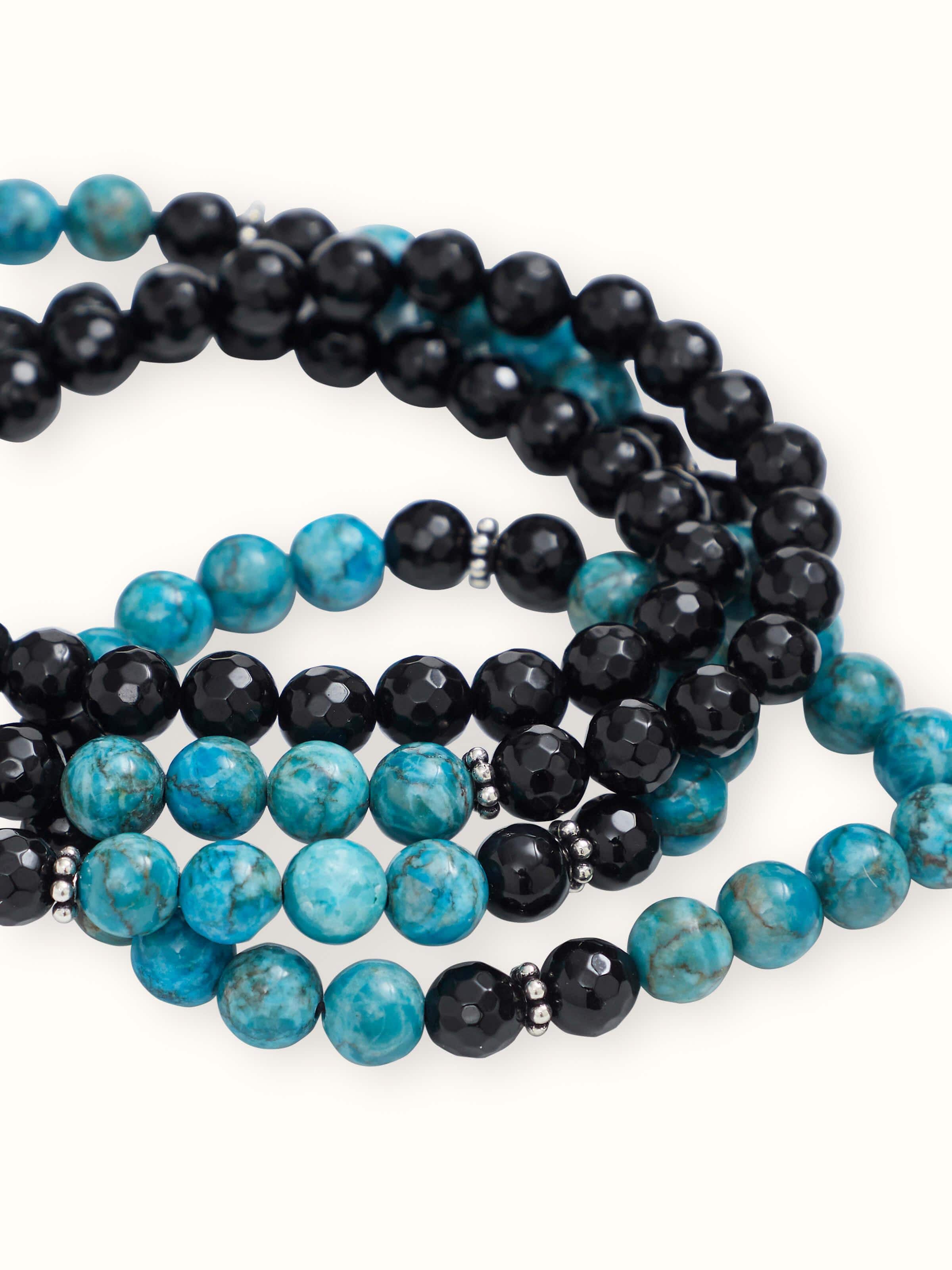 Close-up side detail of Black Onyx & Turquoise Mala showing the bead symmetry and silver thread accents