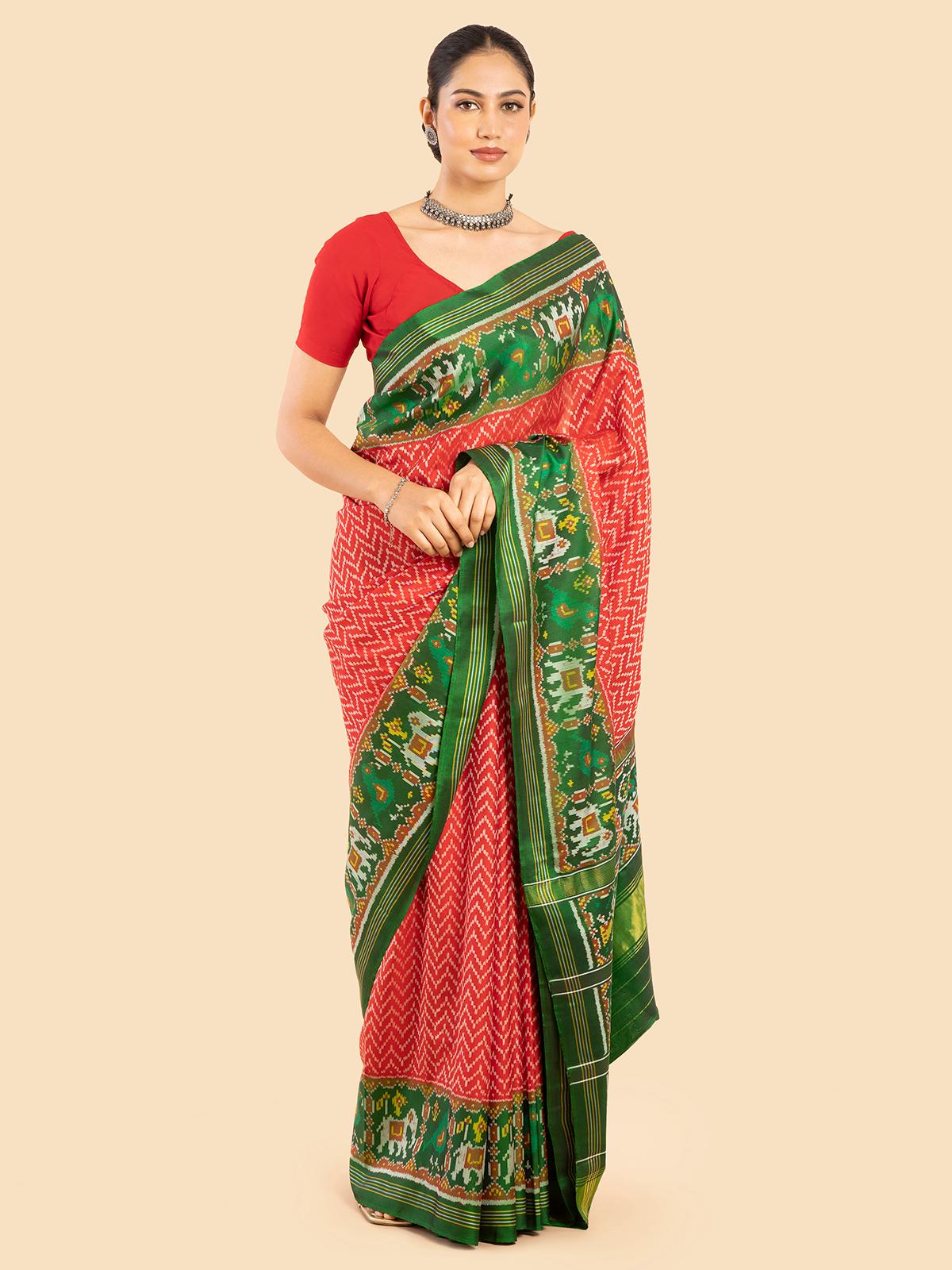 Side view of red silk patola saree showing intricate patterns and luxurious fabric texture