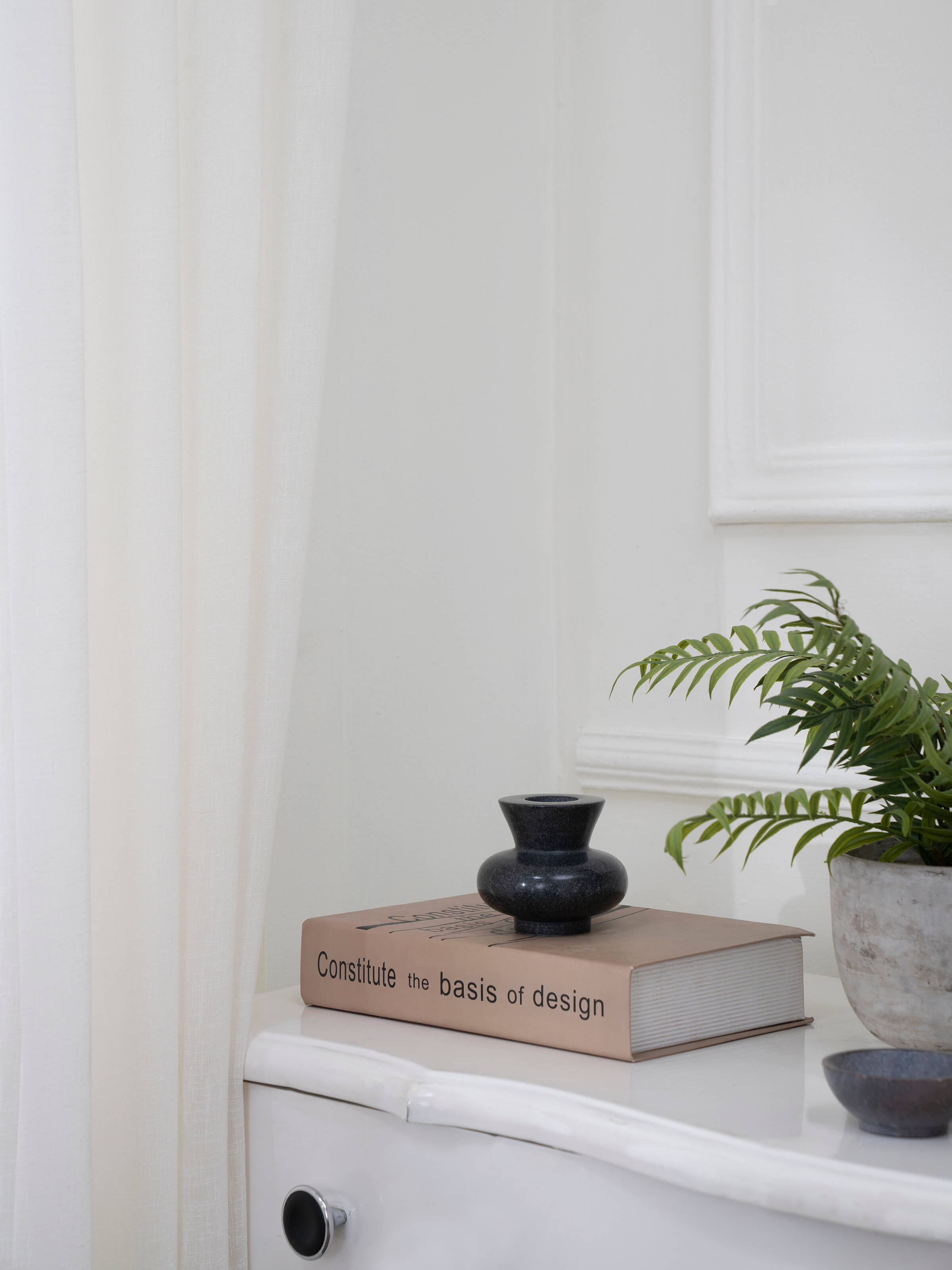 Side view of Carved marble tea light holder in black color highlighting intricate carvings and sleek design.