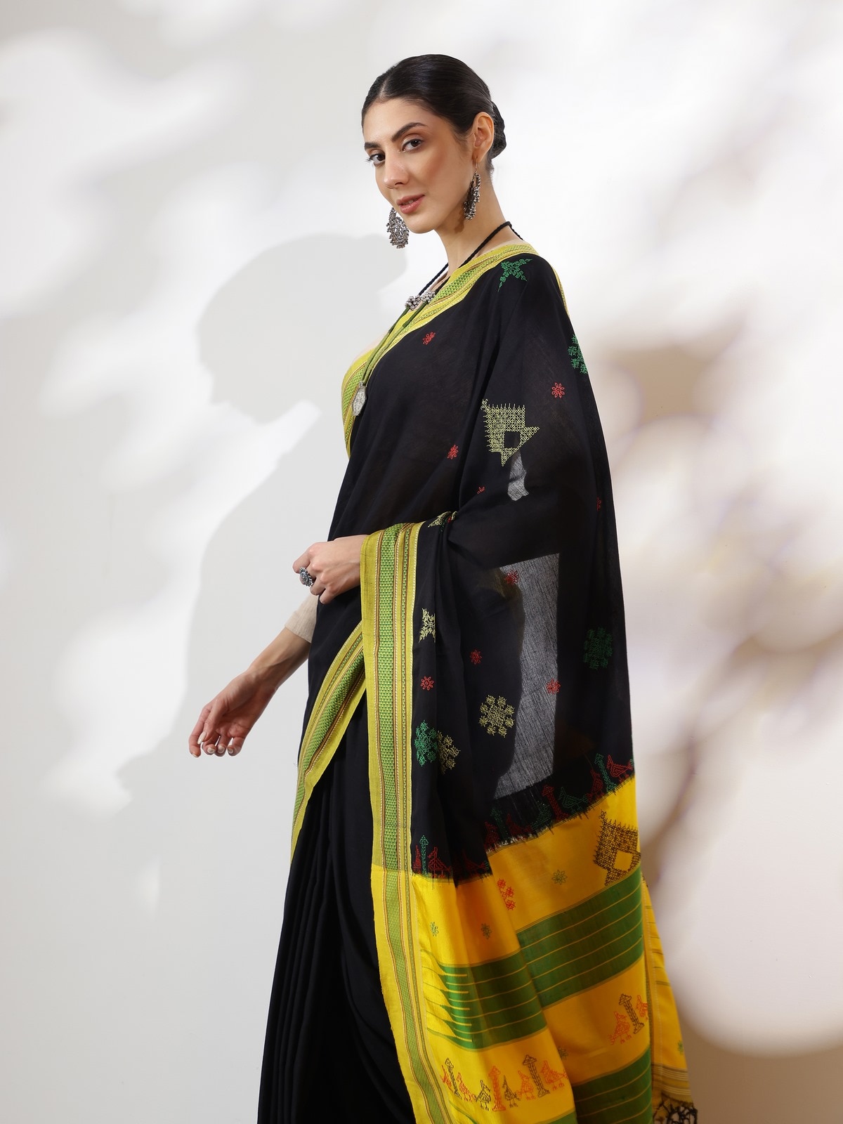 Side view of black cotton silk Kasuti embroidered saree with detailed embroidered motifs