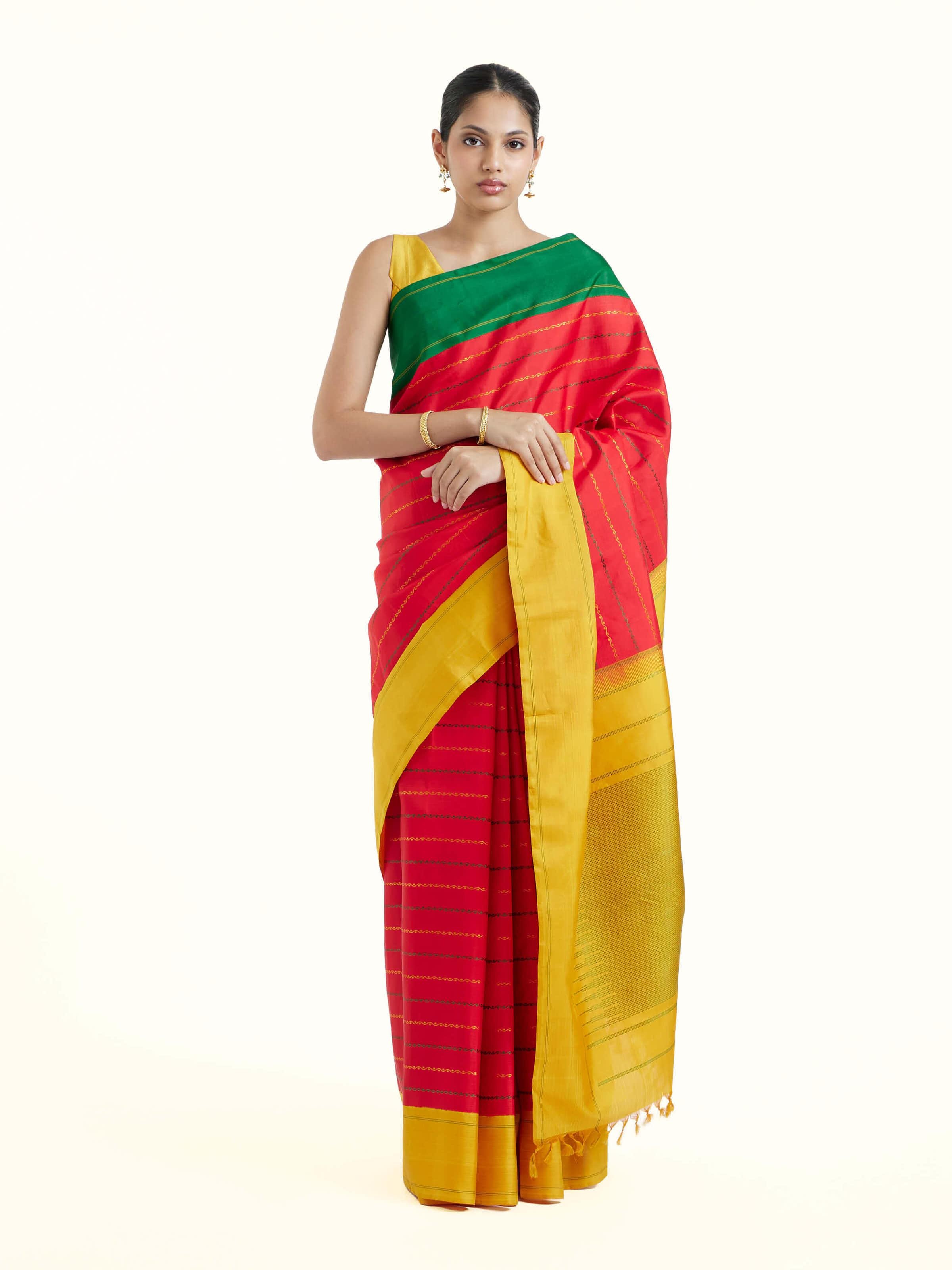Front view of red silk Kancheepuram saree with vibrant zari motifs