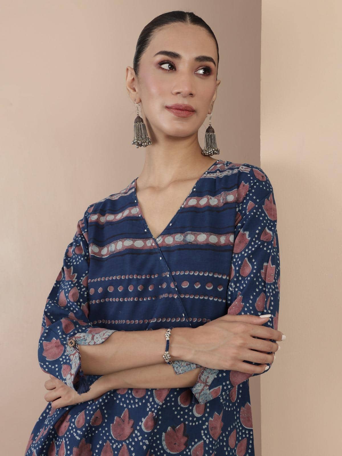 Close-up of hand block print on blue cotton Dabu A-line kurta emphasizing artisan craft.