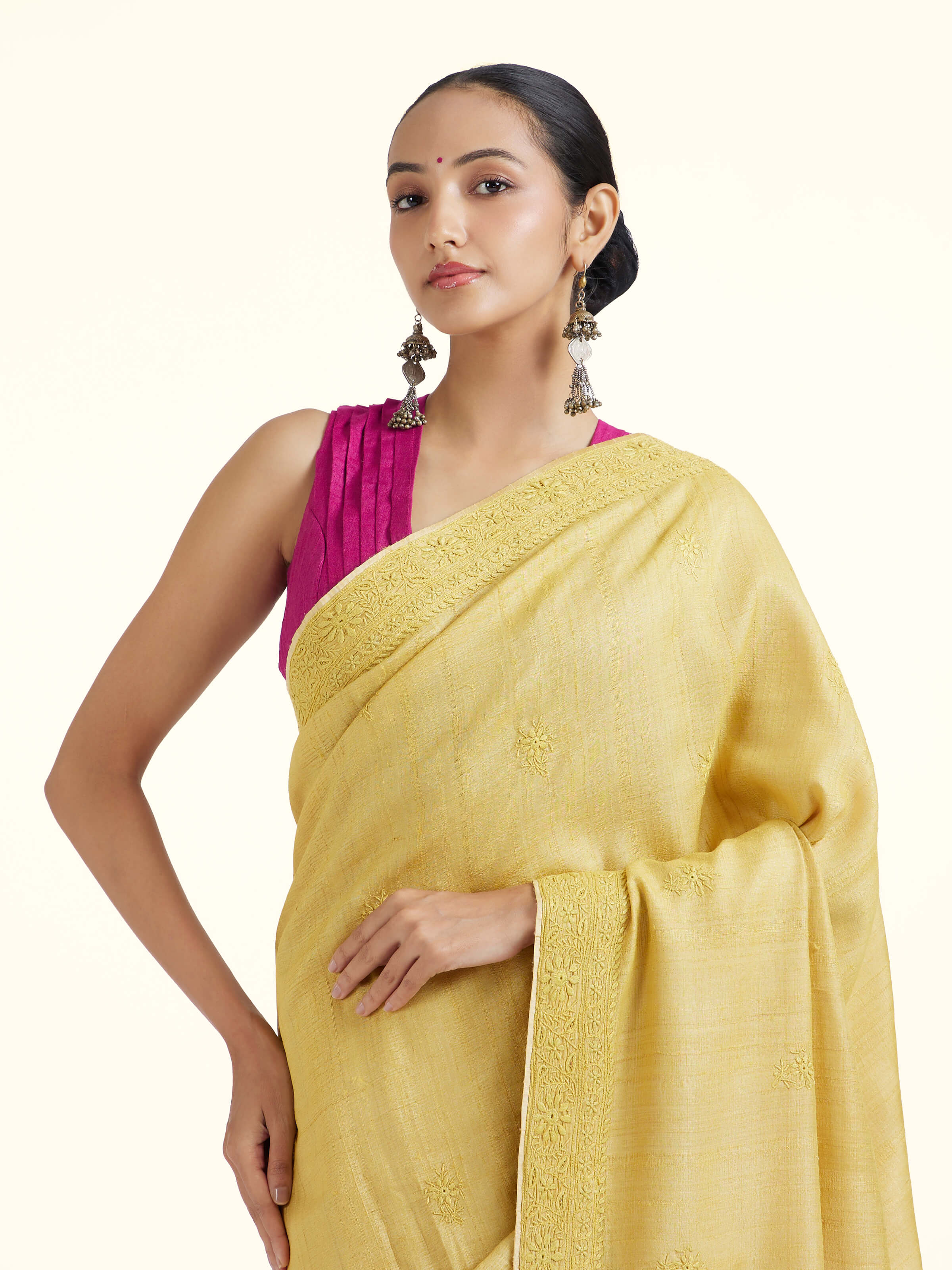 Angled view of yellow silk Chikankari saree highlighting intricate Chikankari work