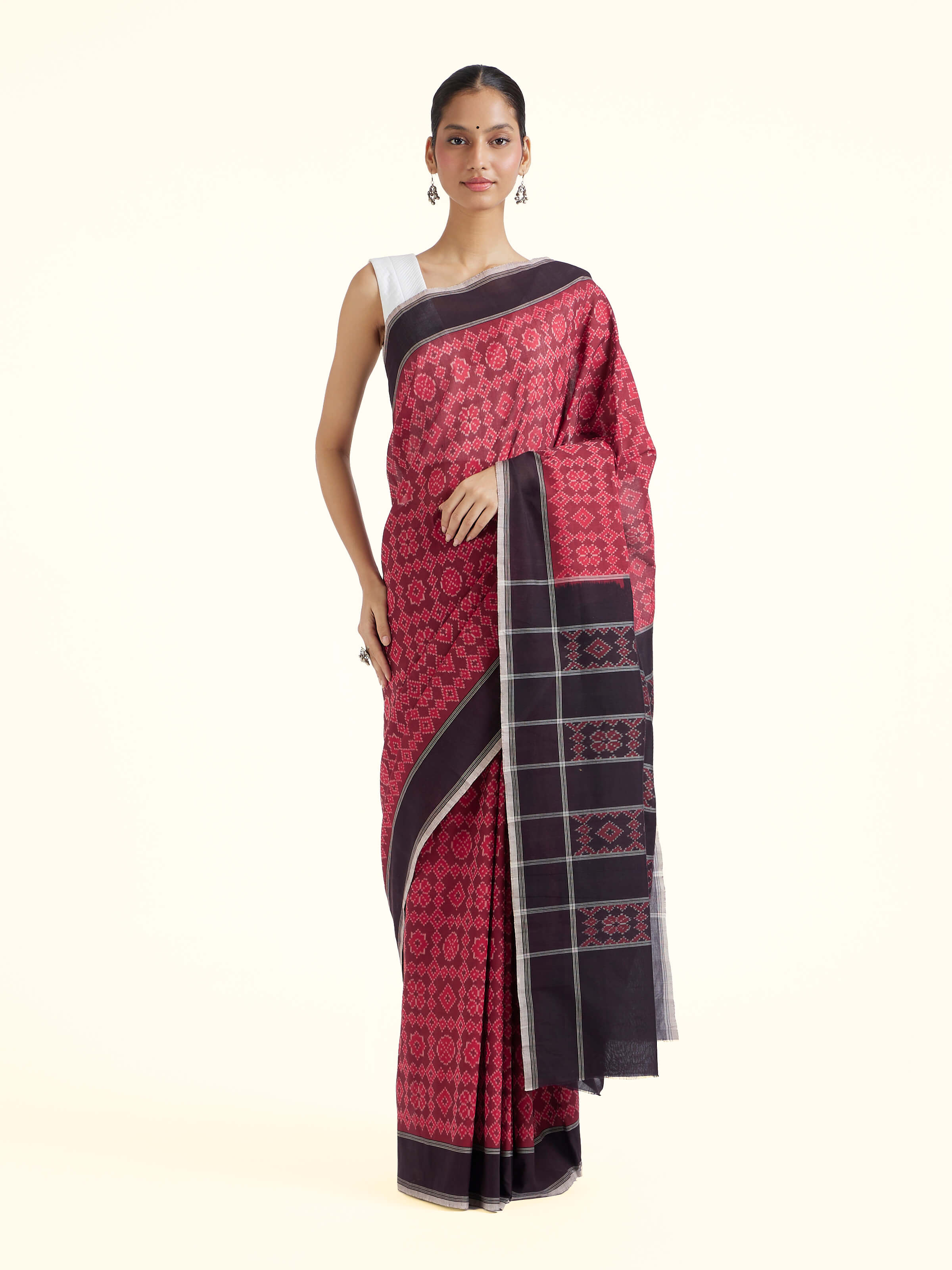 Front view of maroon mulberry silk ikat saree showcasing traditional ikat motifs