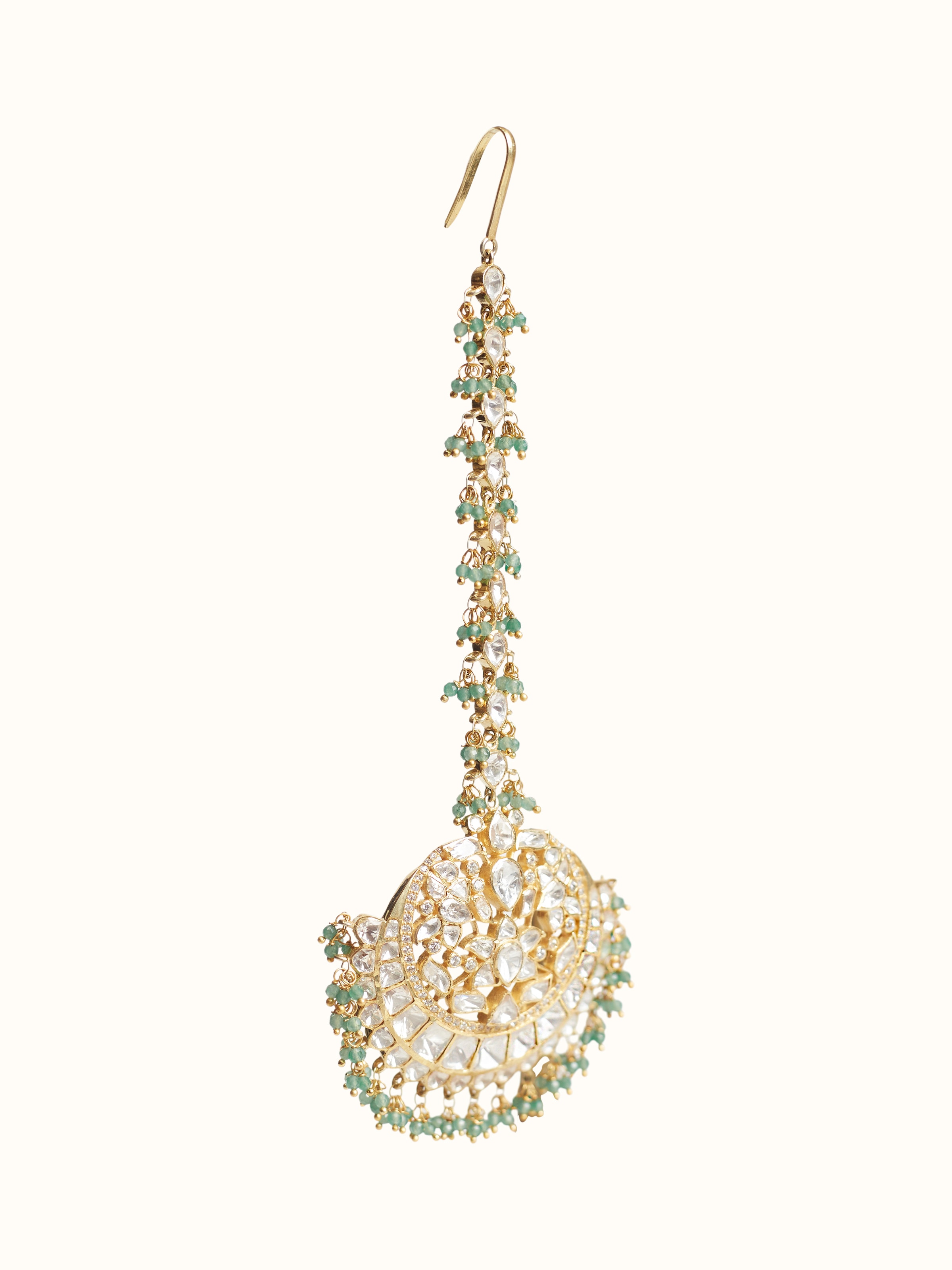 Angled view of silver smithing maang tika