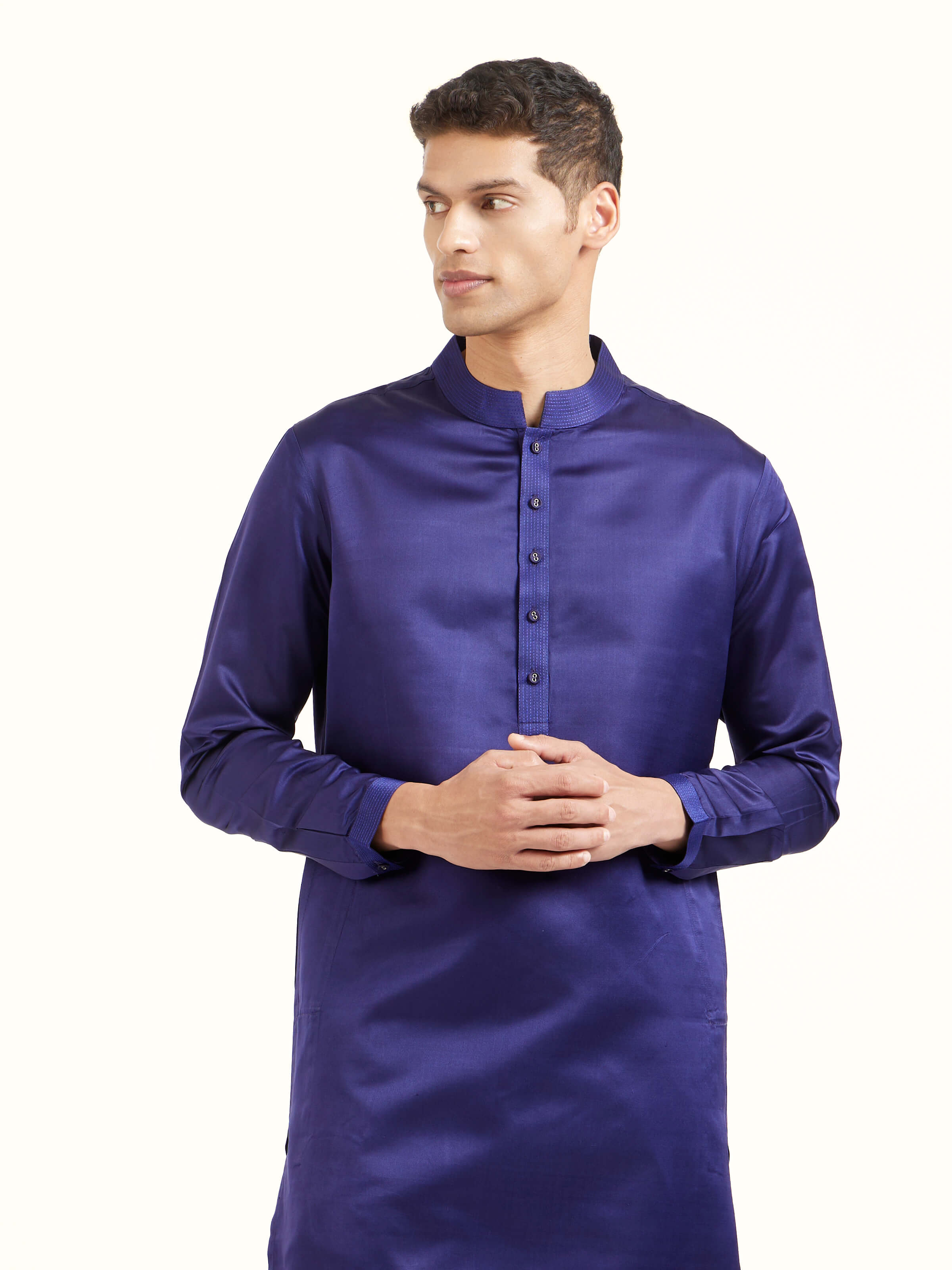 Angled view of navy blue katan silk Banarasi midi kurta pant set highlighting zari work