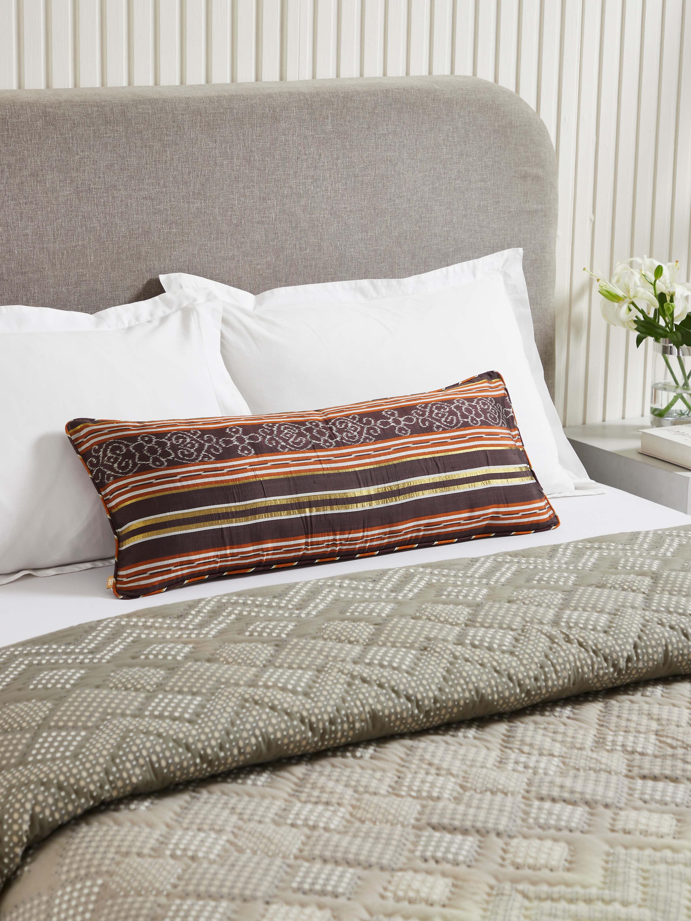 Top-down shot highlighting the intricate Ikat weaving and rich silk texture