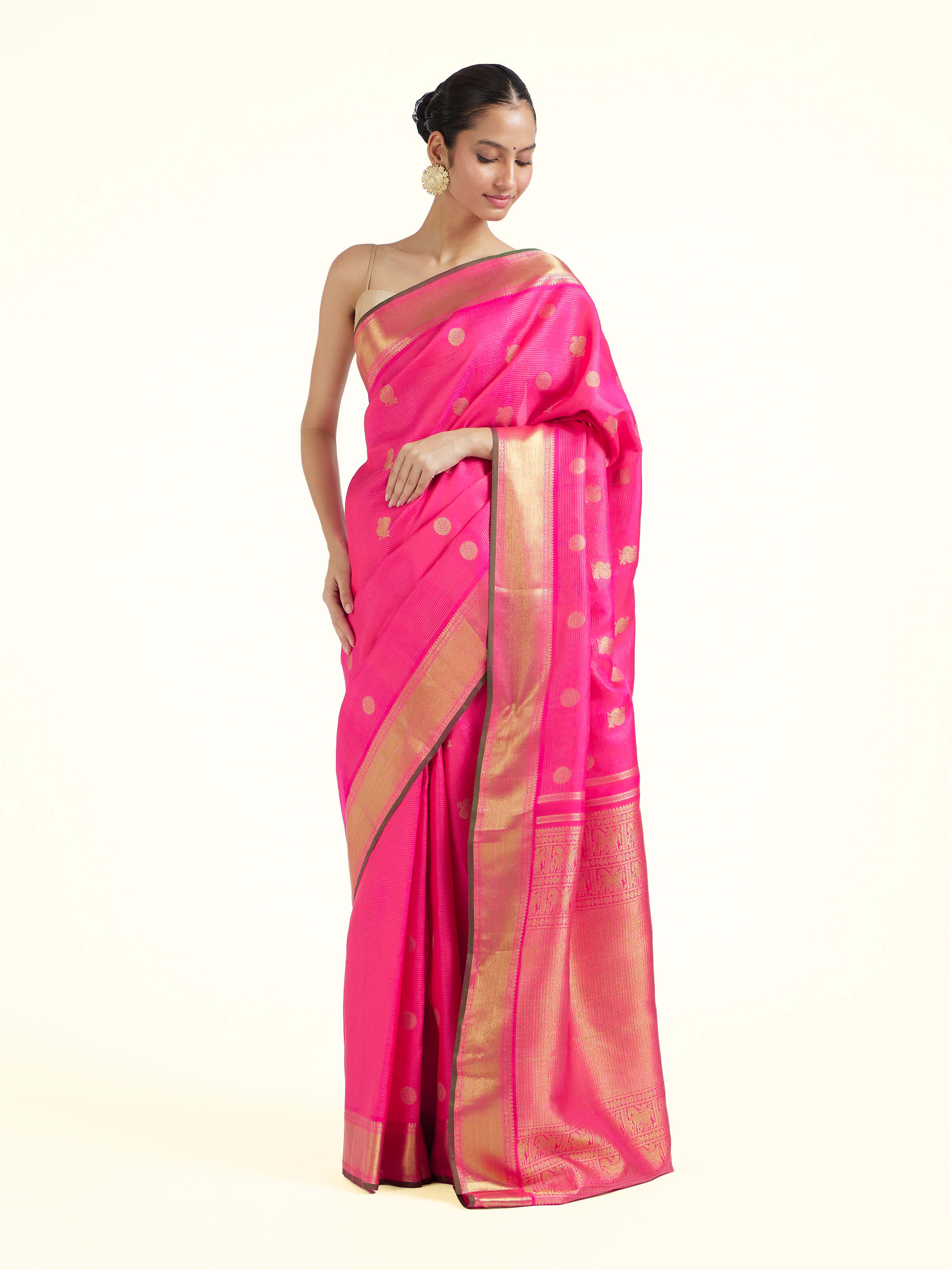 Side view of pink silk Kancheepuram saree with graceful drape and broad border