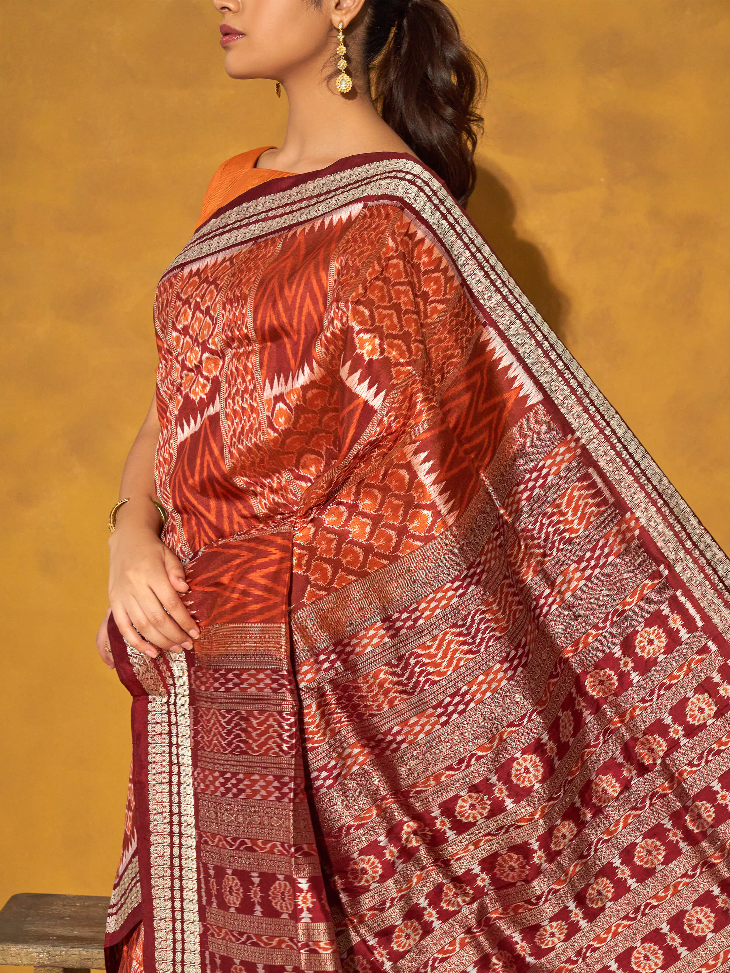Detail view of brown mulberry silk bandha Odisha saree showing fabric weave