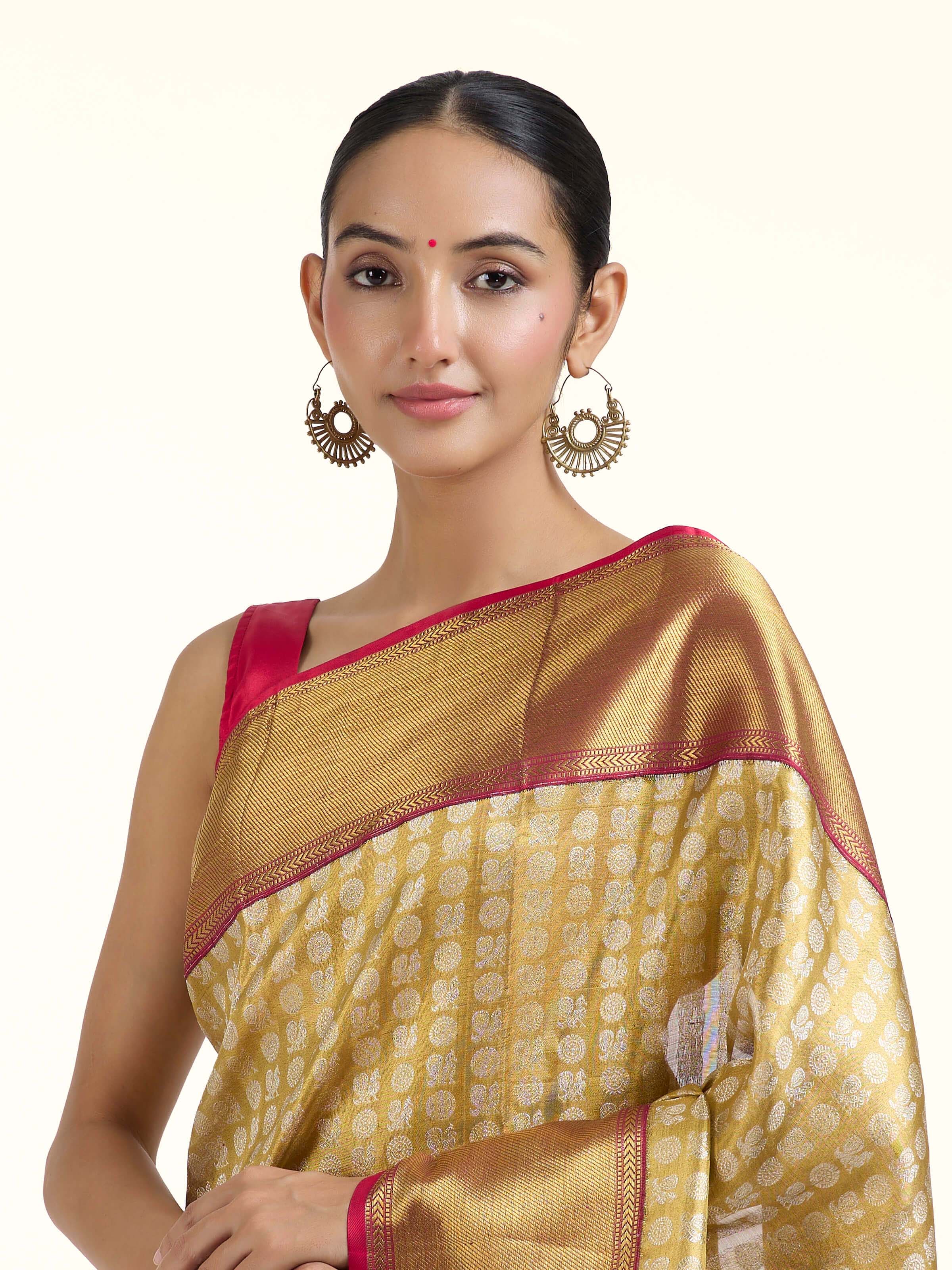 Angled view of gold silk Kancheepuram saree highlighting intricate zari craftsmanship