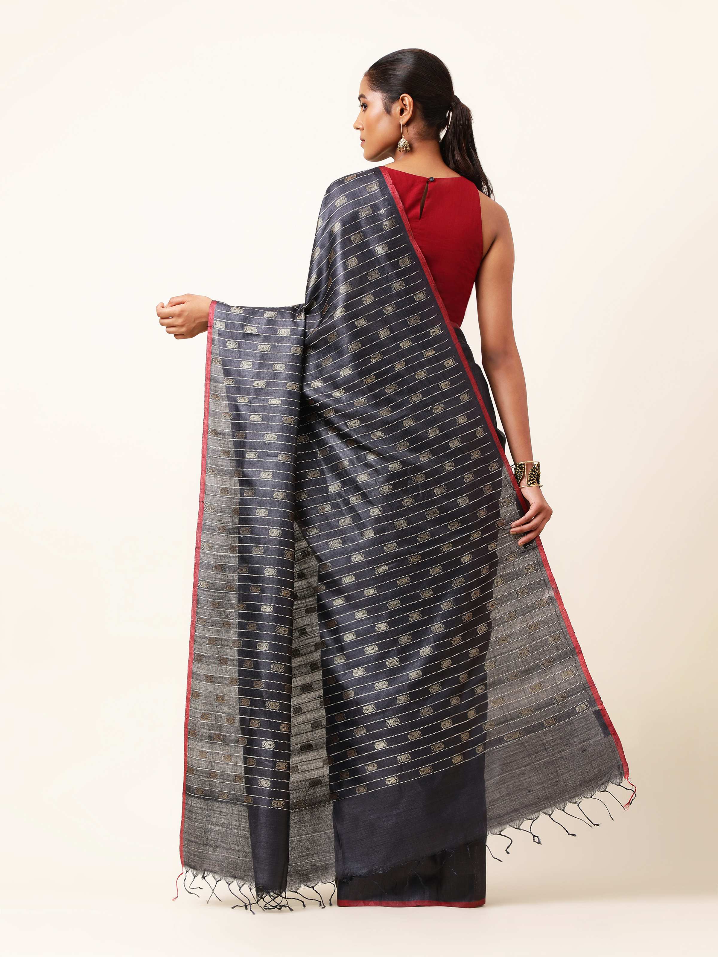 Back view highlighting pallu design and craftsmanship of handwoven Ikat.
