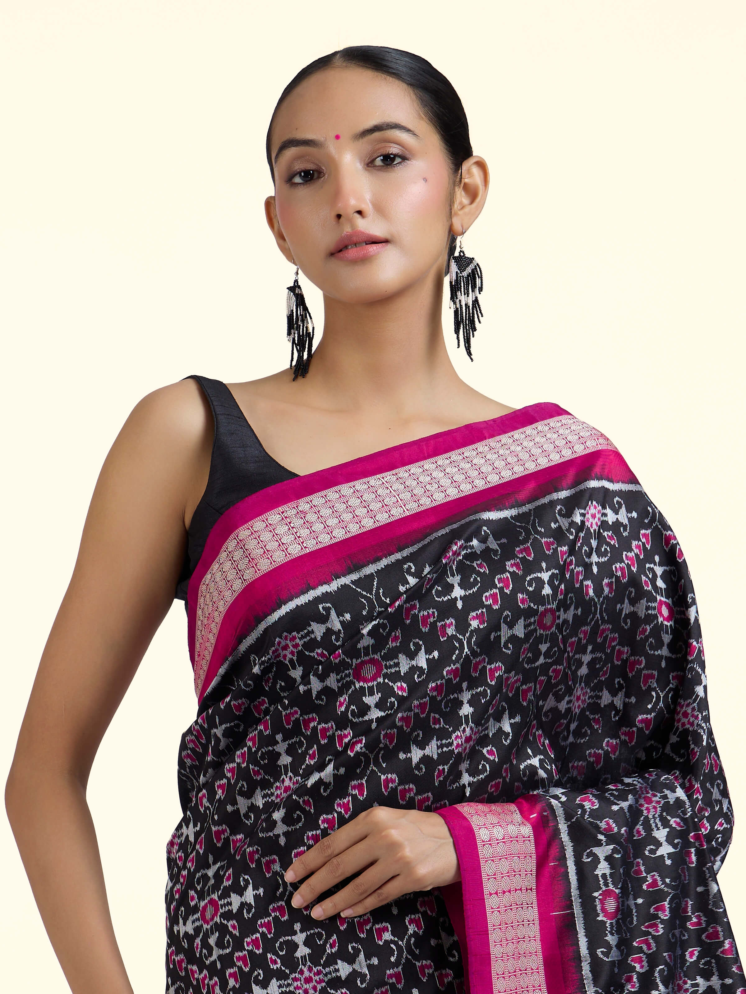 Angled view of black mulberry silk Bandha Odisha Ikat saree emphasizing weaving technique