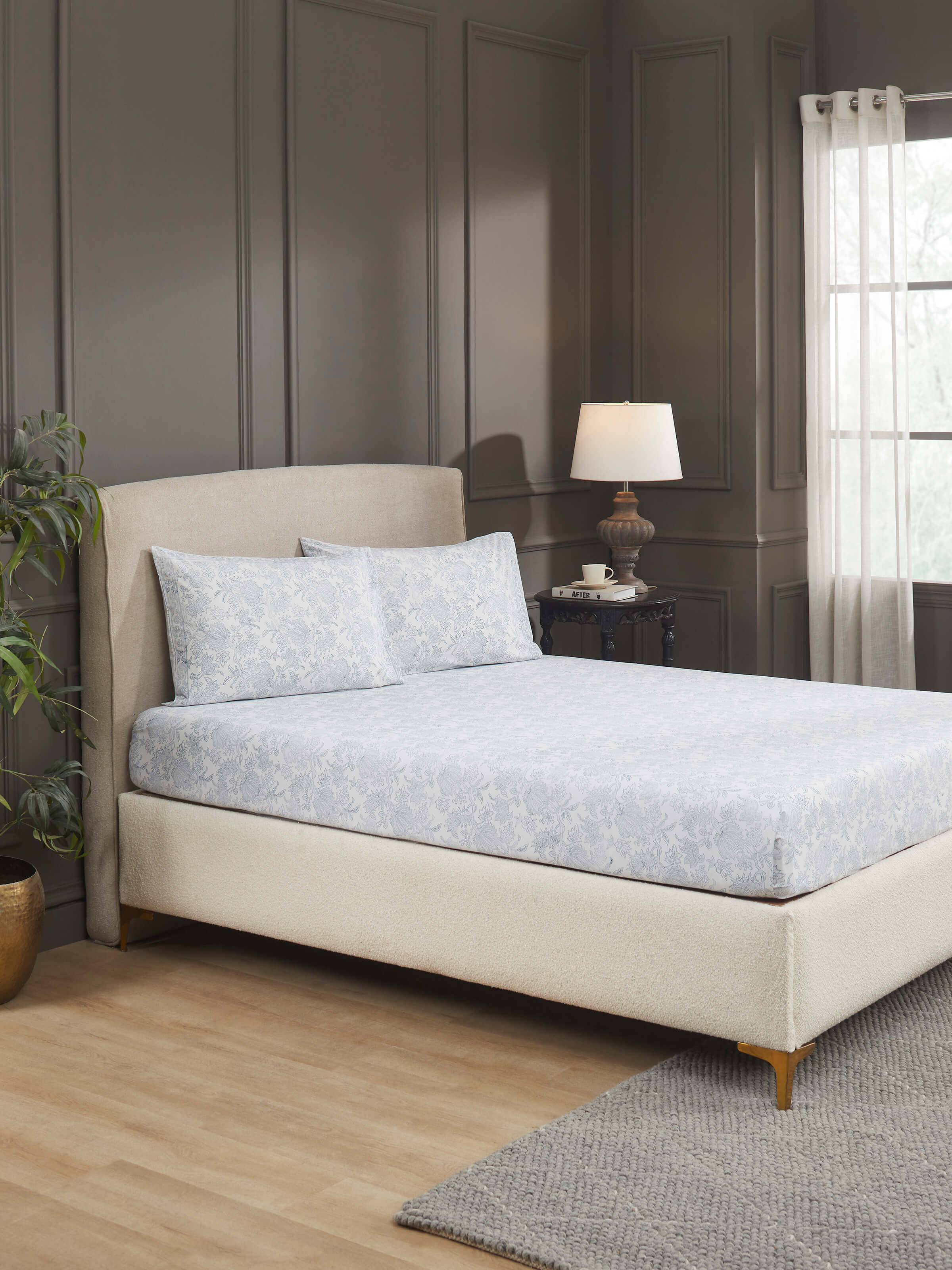 Lifestyle image showing the bedsheet set styled in a bedroom setup, showcasing vibrant traditional Indian aesthetics.