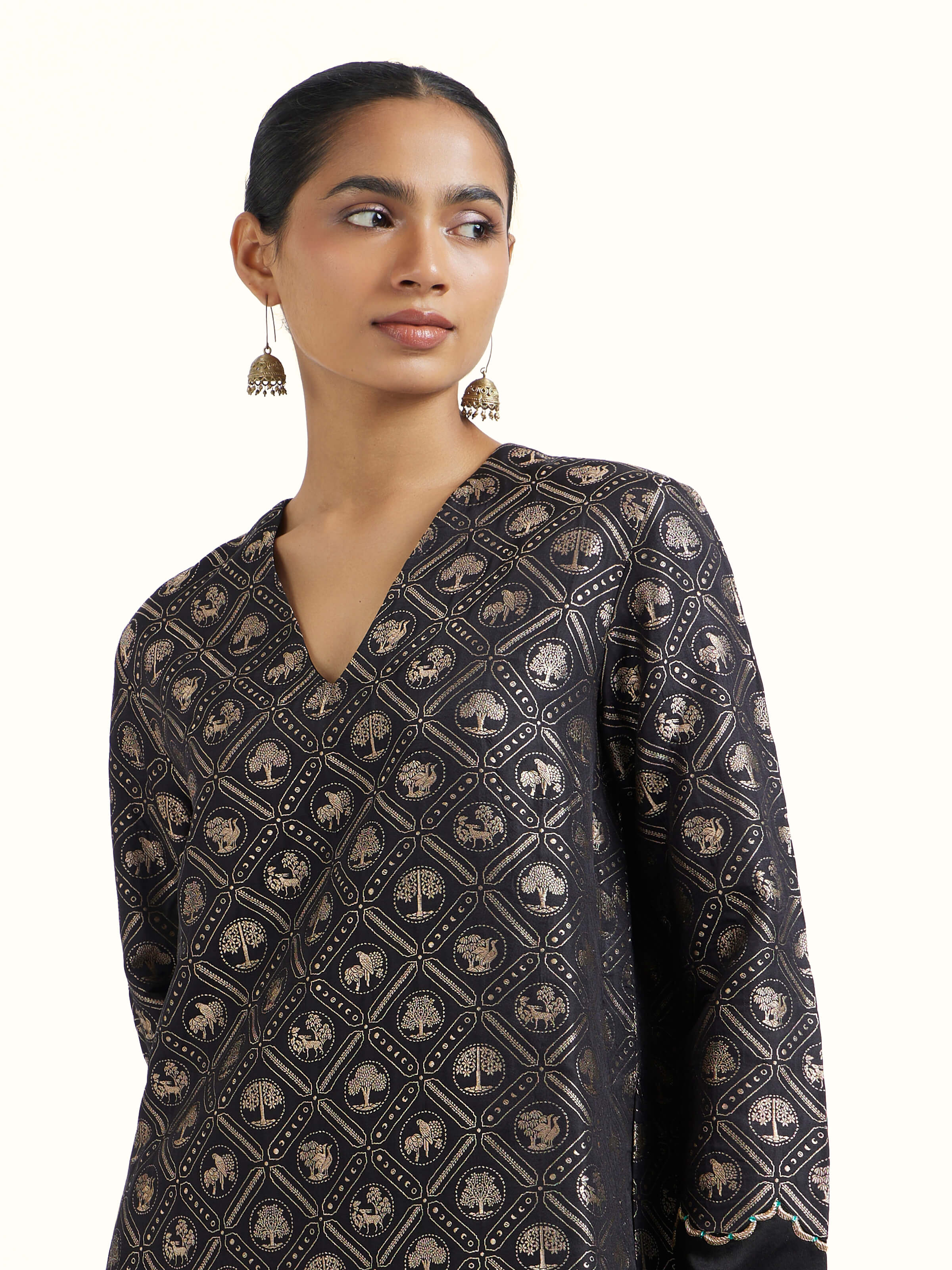 Angled view of black silk Banarasi kurta set emphasizing woven details