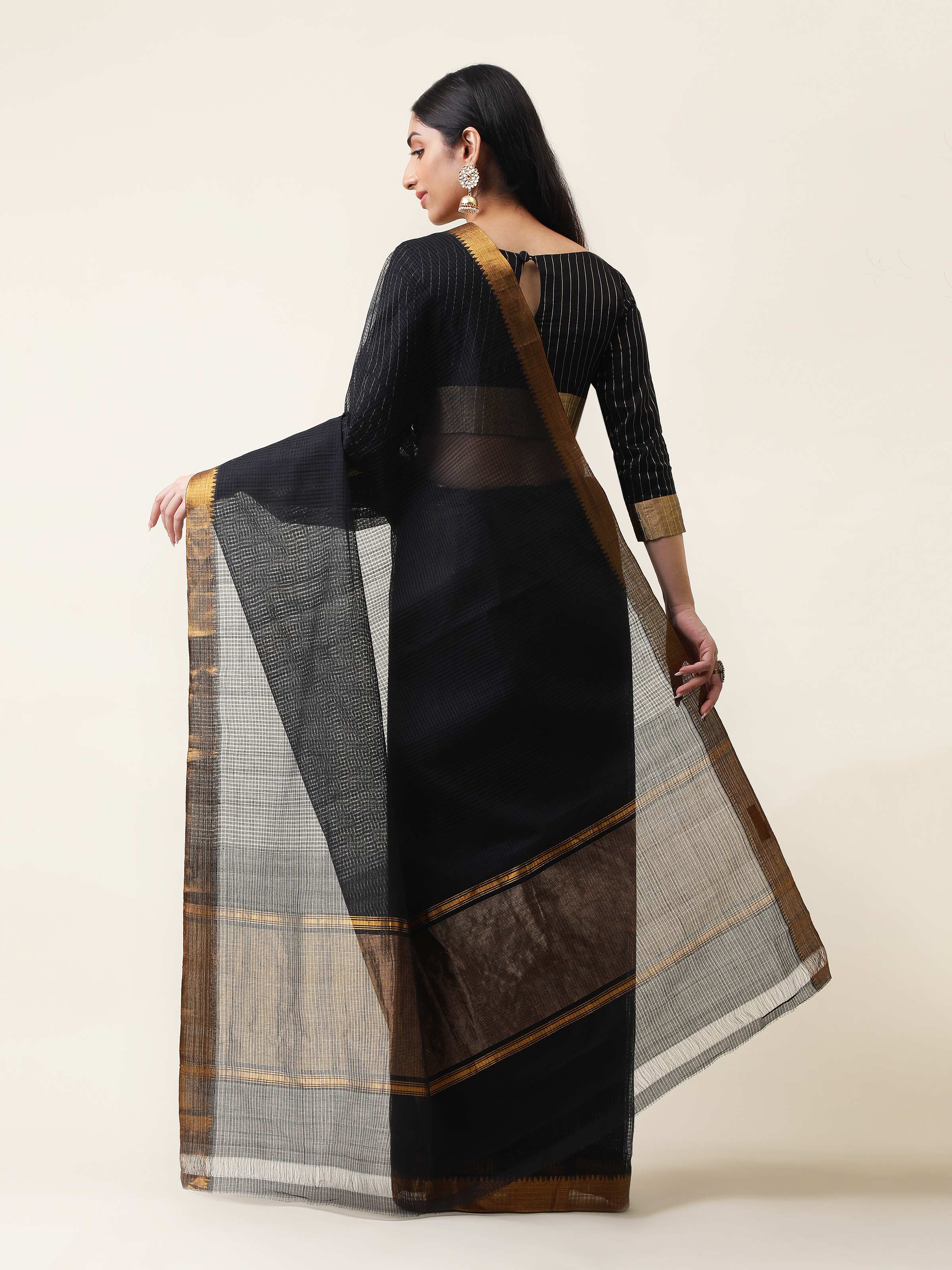 Back view of black cotton blend Mangalgiri saree showcasing pallu design and fabric flow.