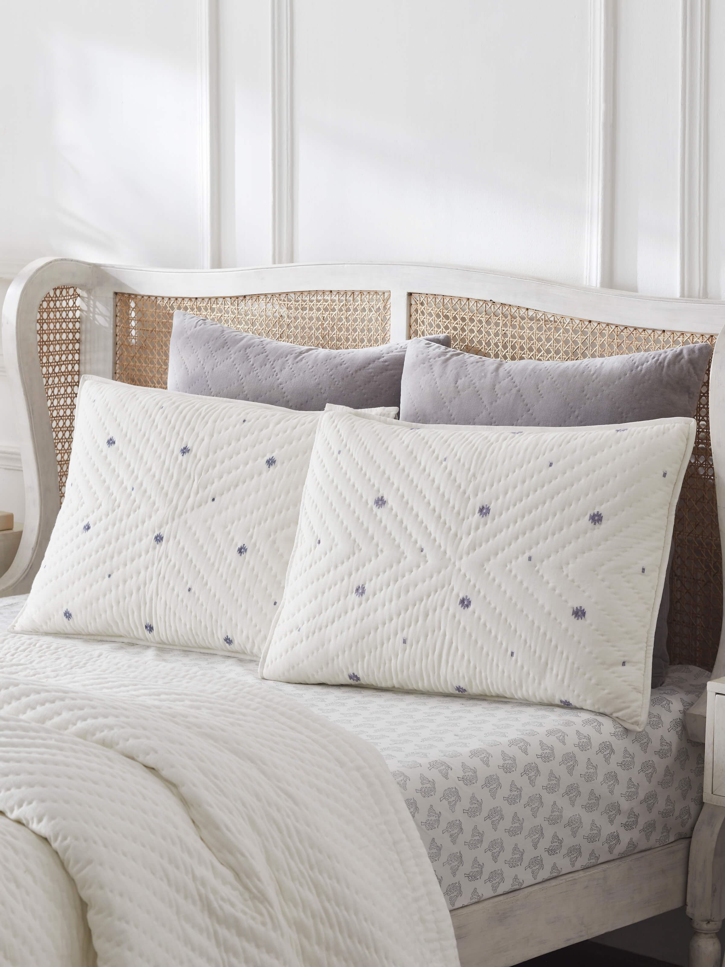 Lifestyle image showing Kalpanama Ivory Buti Cotton Pillow Shams styled on a bed