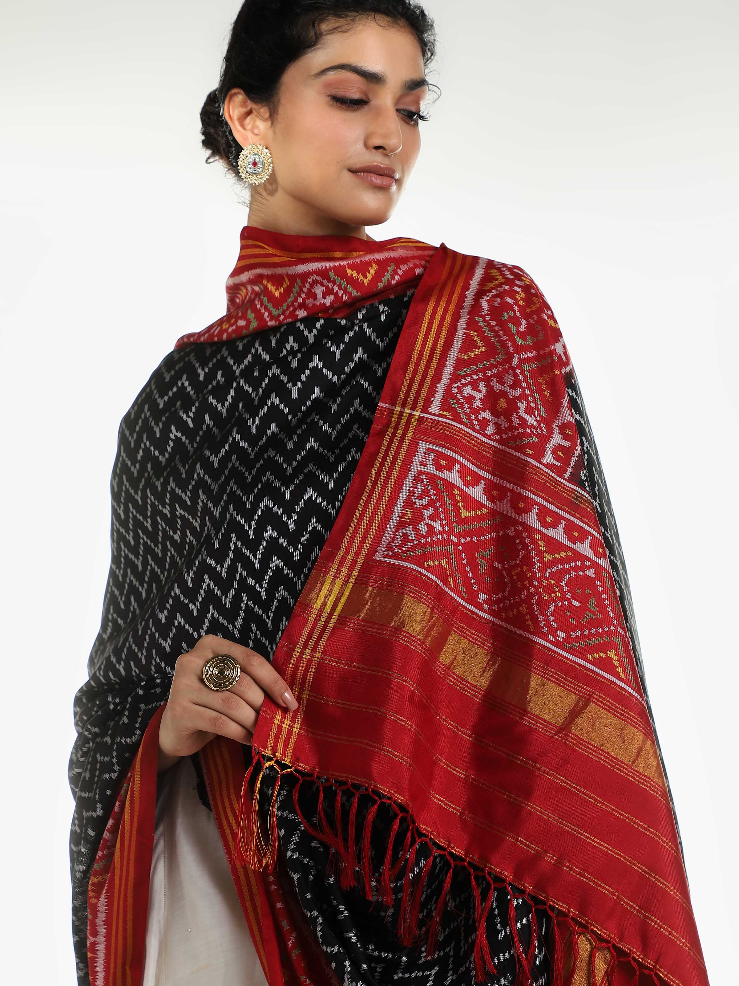 Detail view of black silk Patola dupatta with fabric texture and weave