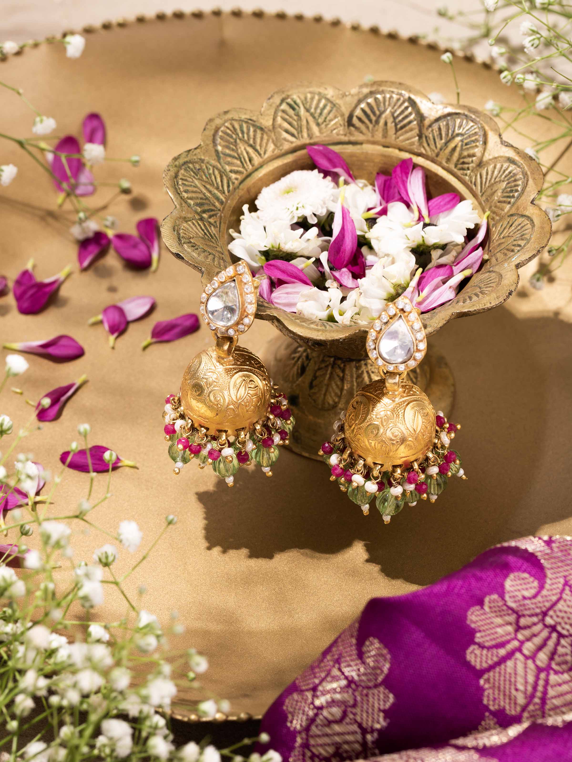 Close-up side angle showing delicate patterns and craftsmanship of jhumkas