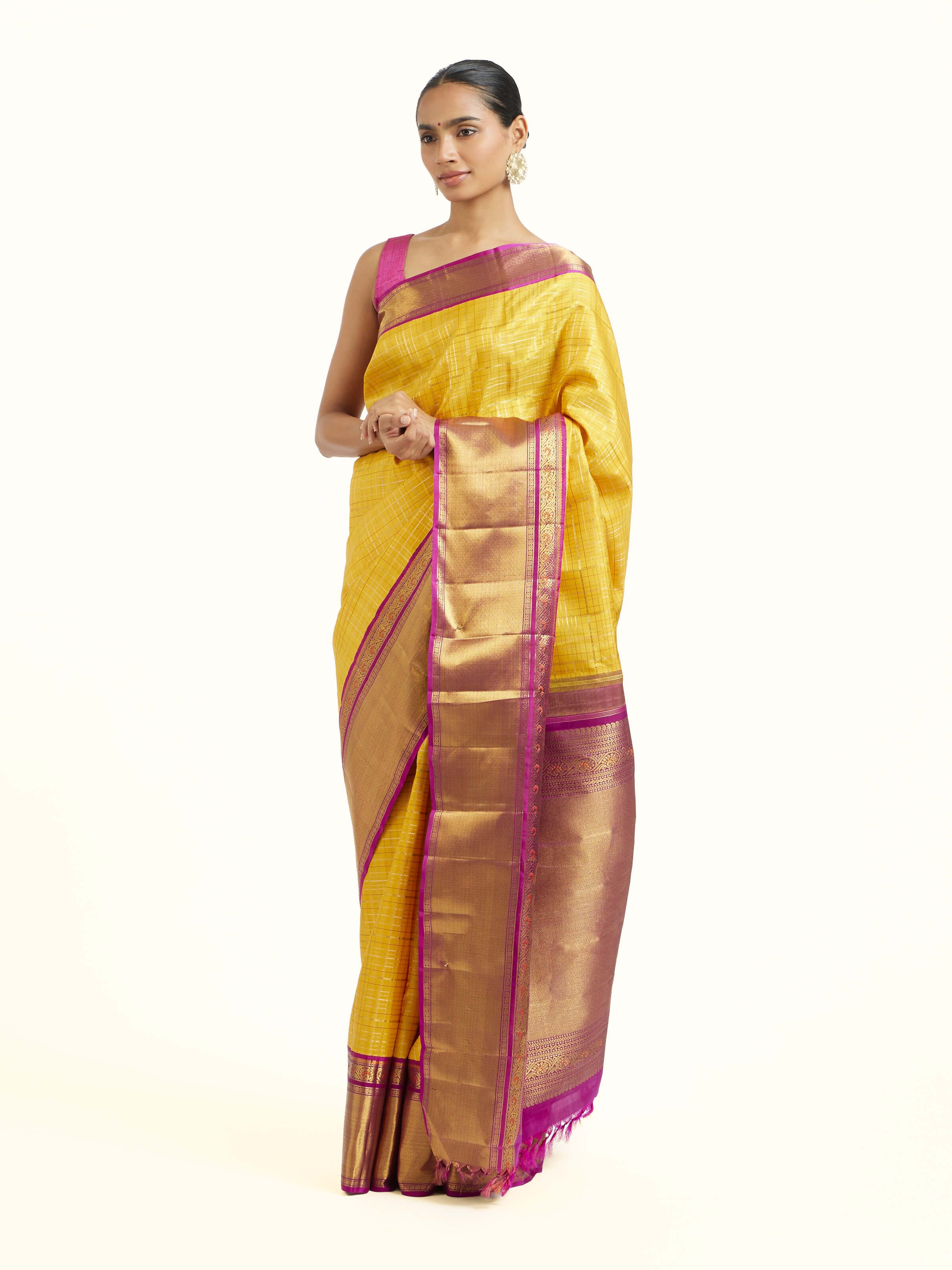 Side view of yellow silk Kancheepuram saree showcasing contrast border