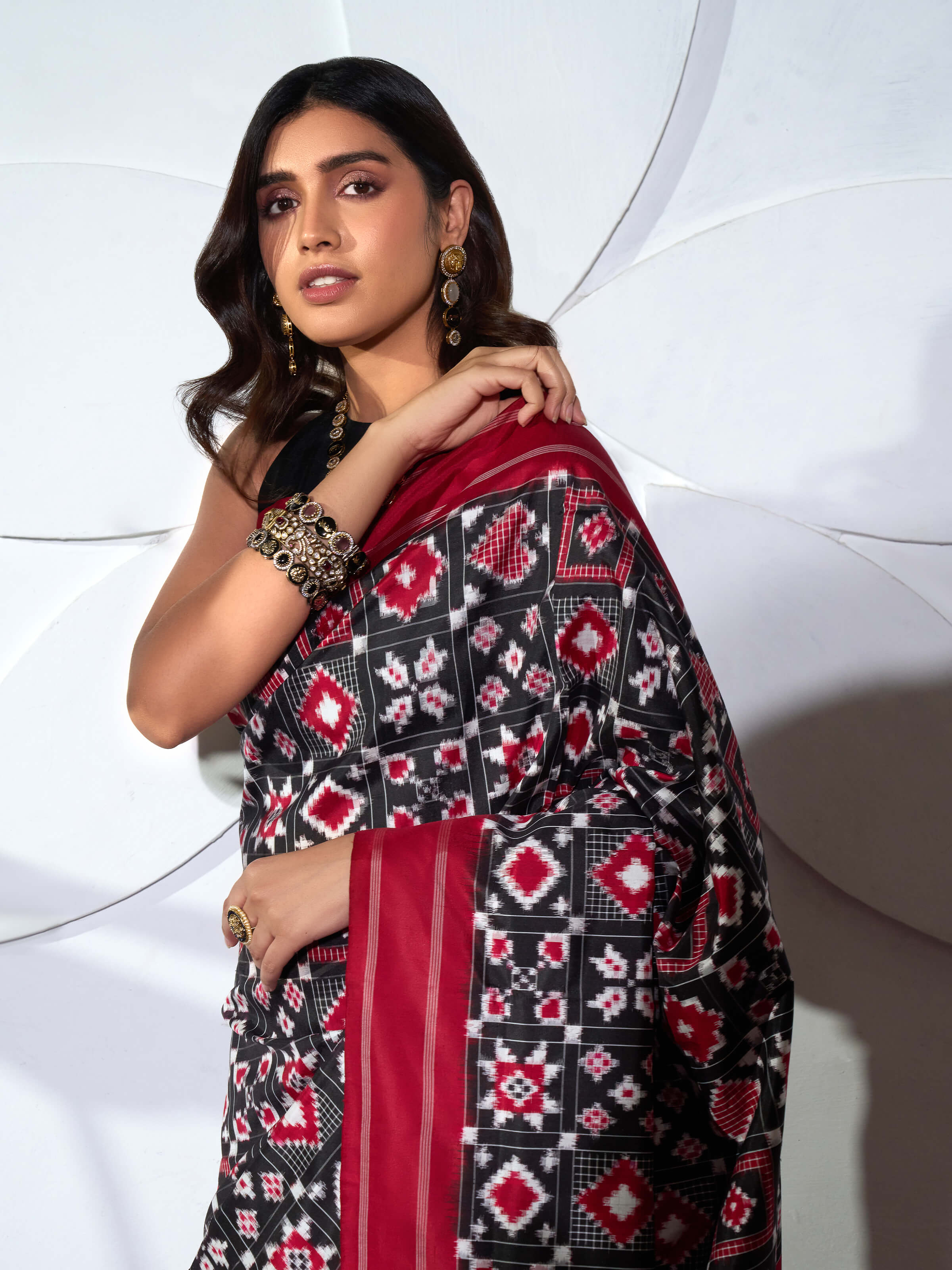 Detail view of red silk Telia Rumal double ikat saree showing silk texture and ikat craftsmanship