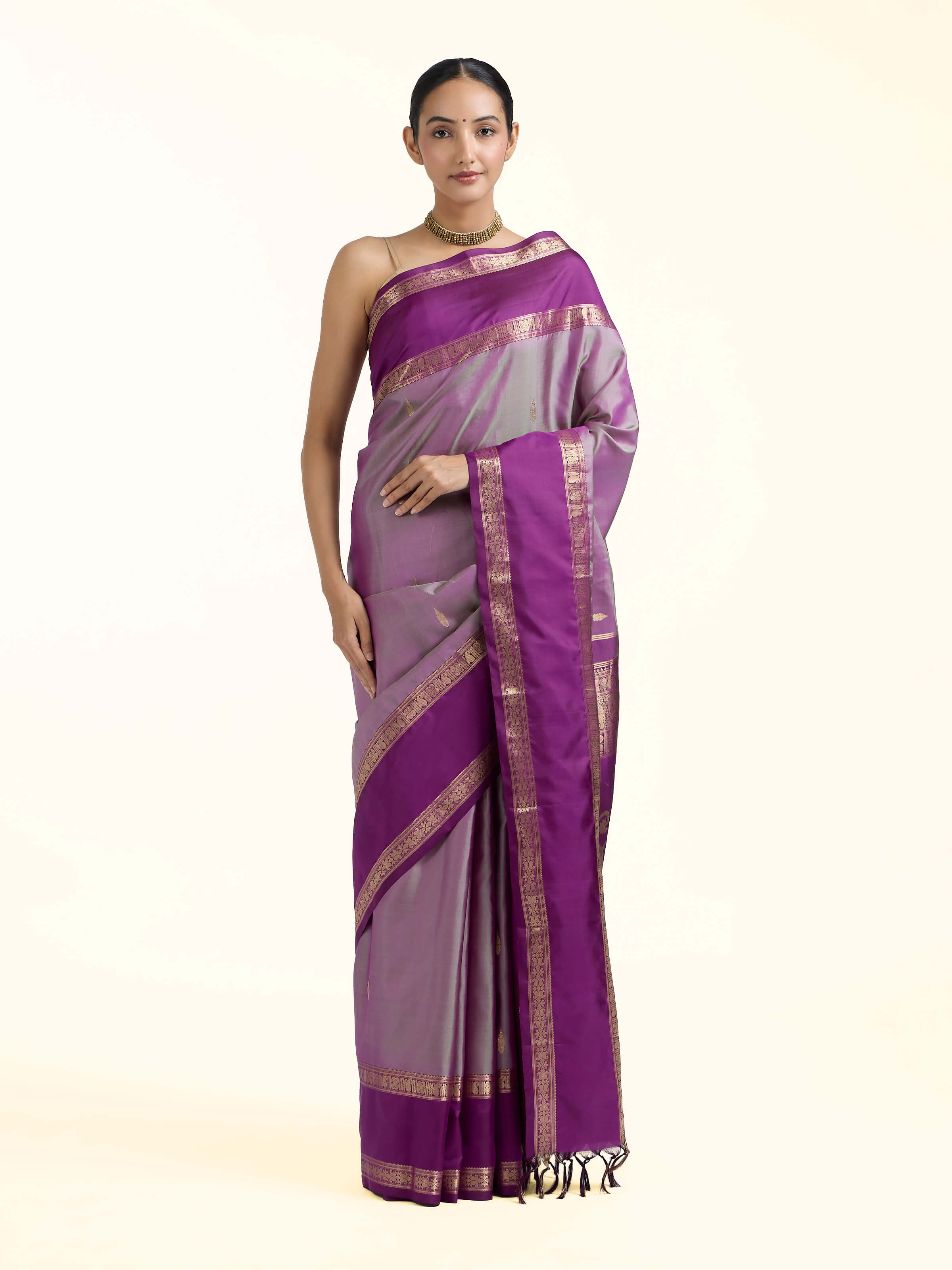 Front view of purple silk Kancheepuram saree showcasing rich zari motifs