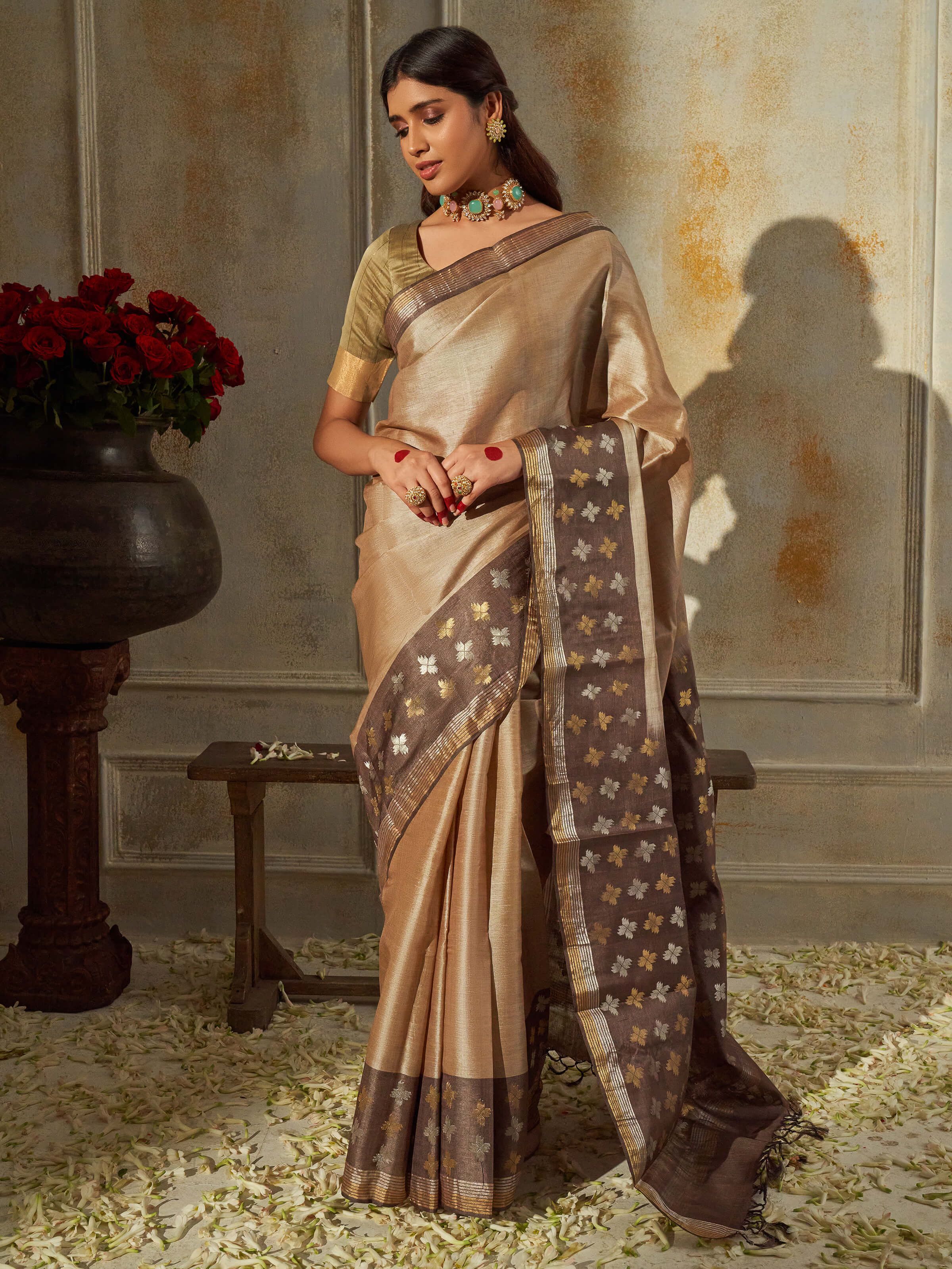 Side view highlighting drape and flow of beige tussar silk saree