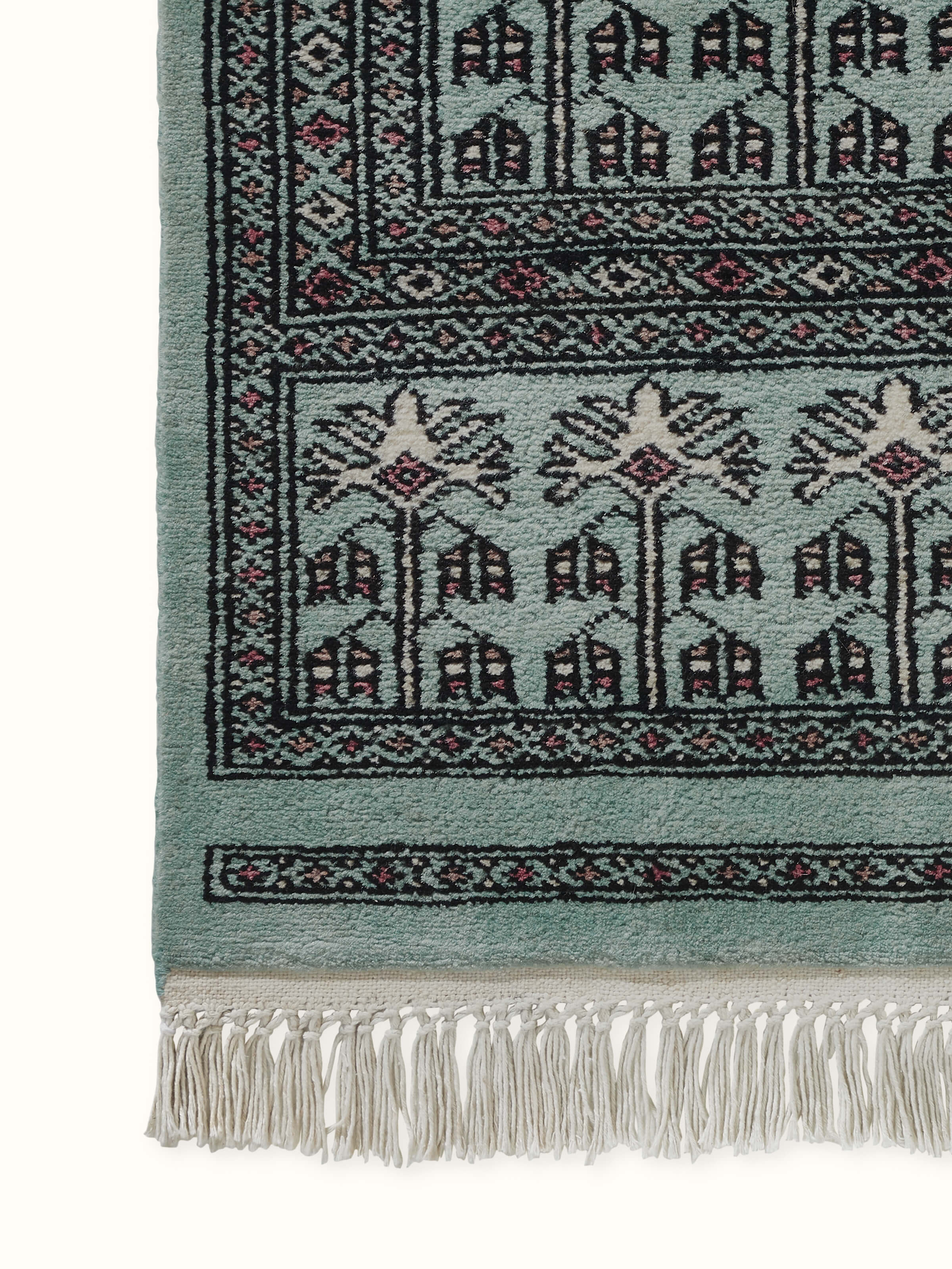 Detail view of floral layout and hand-knotting in blue Parda carpet