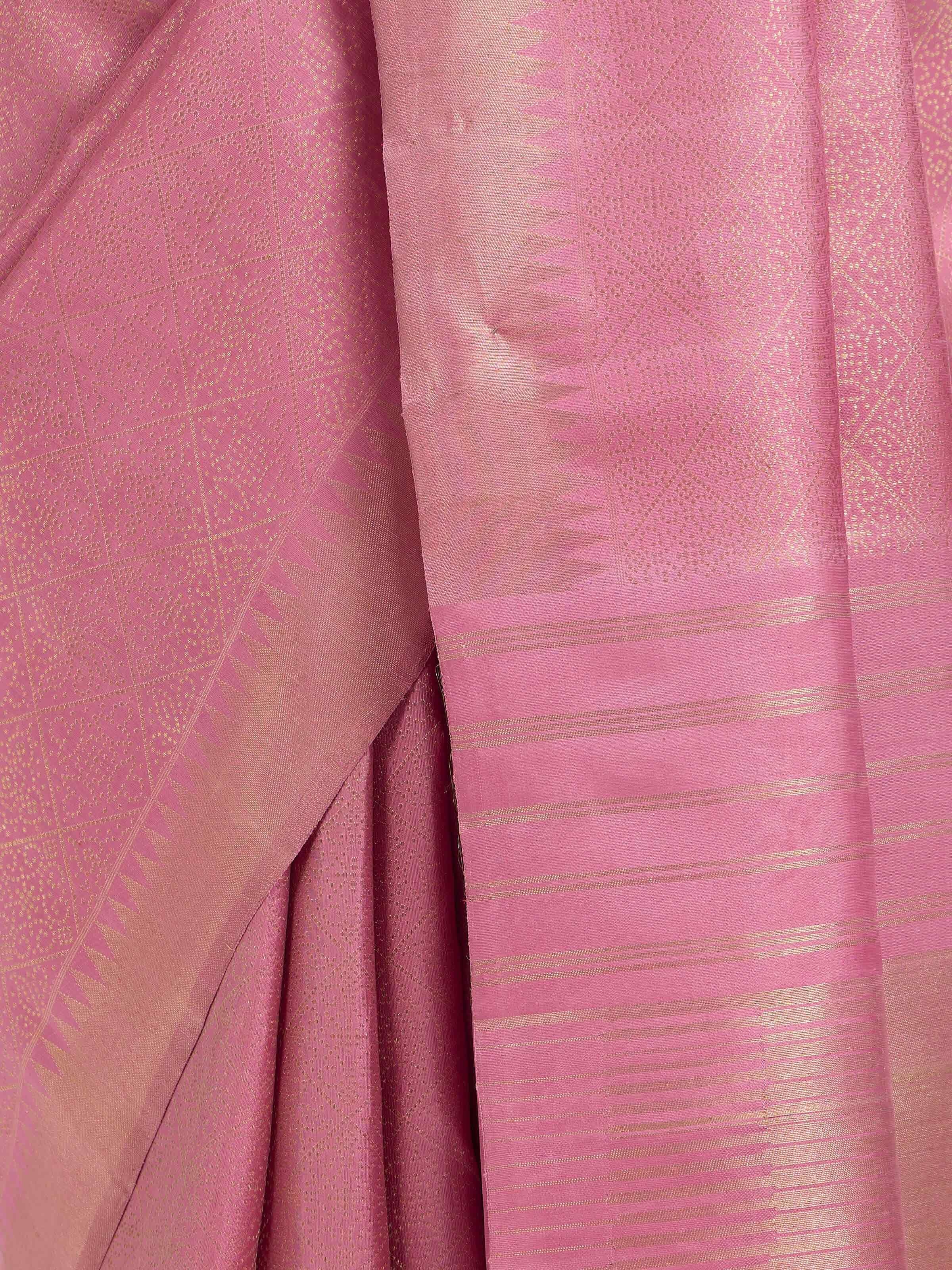 Detail view of light pink silk Kancheepuram saree showing silk texture and zari work