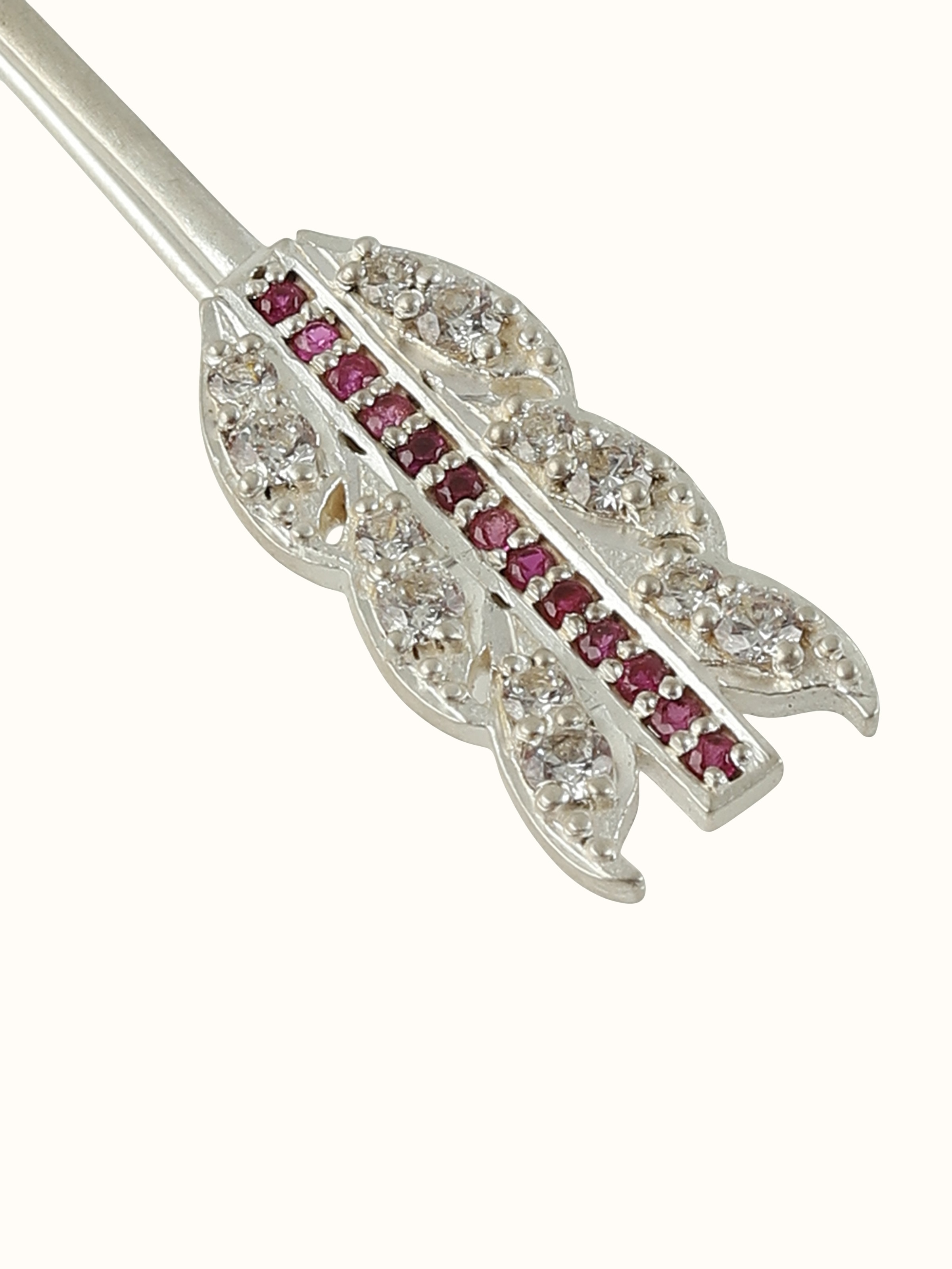 Detail shot capturing fine engraving and handmade detailing of silver pin